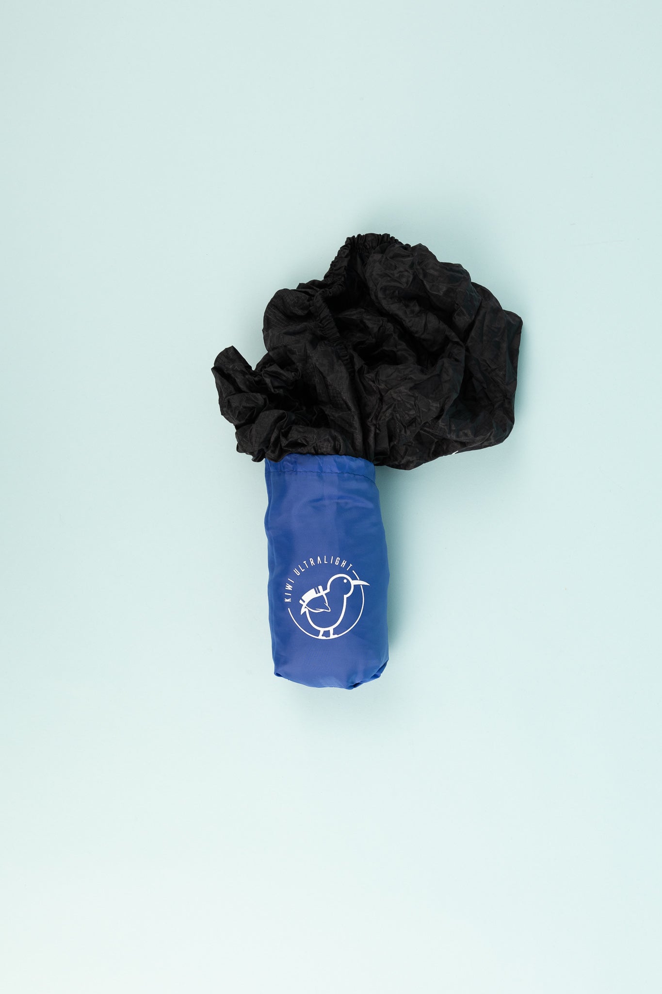 Kiwi Ultralight Sleeping Pad Fitted Sheet packed in a blue carrying bag with a black sheet.