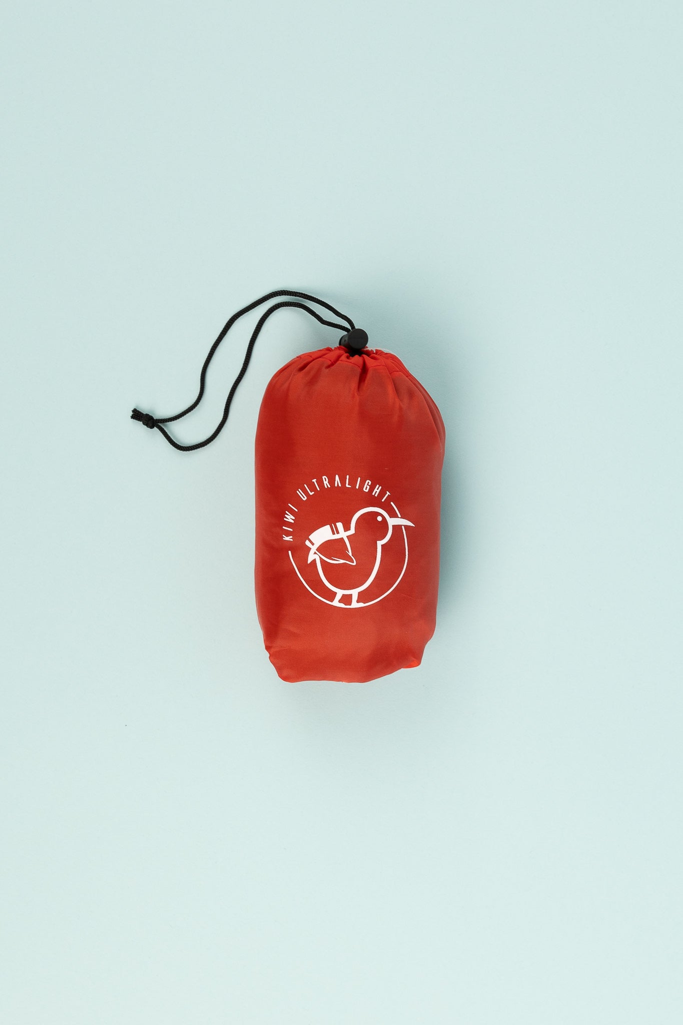 Kiwi Ultralight Sleeping Pad Fitted Sheet packed in a red stuff sack with a logo.