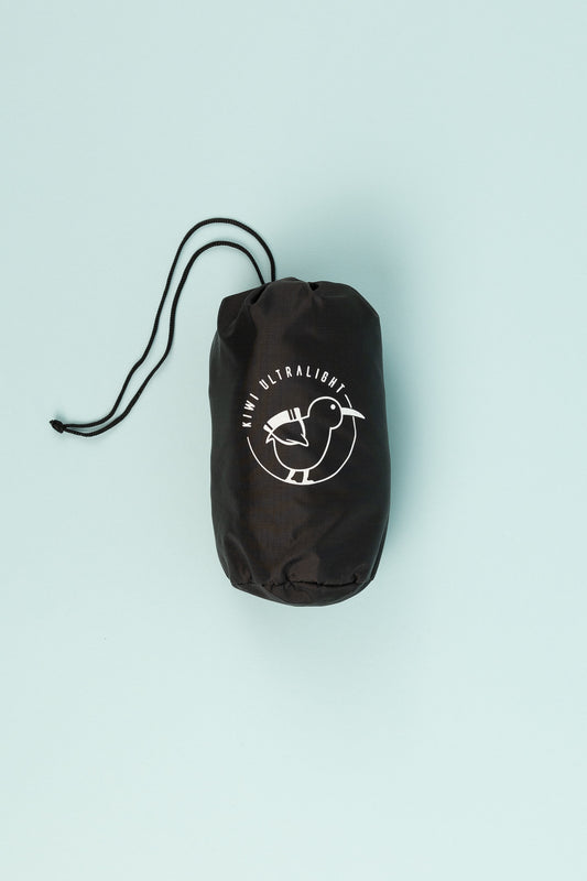 Kiwi Ultralight DOC Hut Mat Fitted Sheet storage bag, compact and durable with logo design.