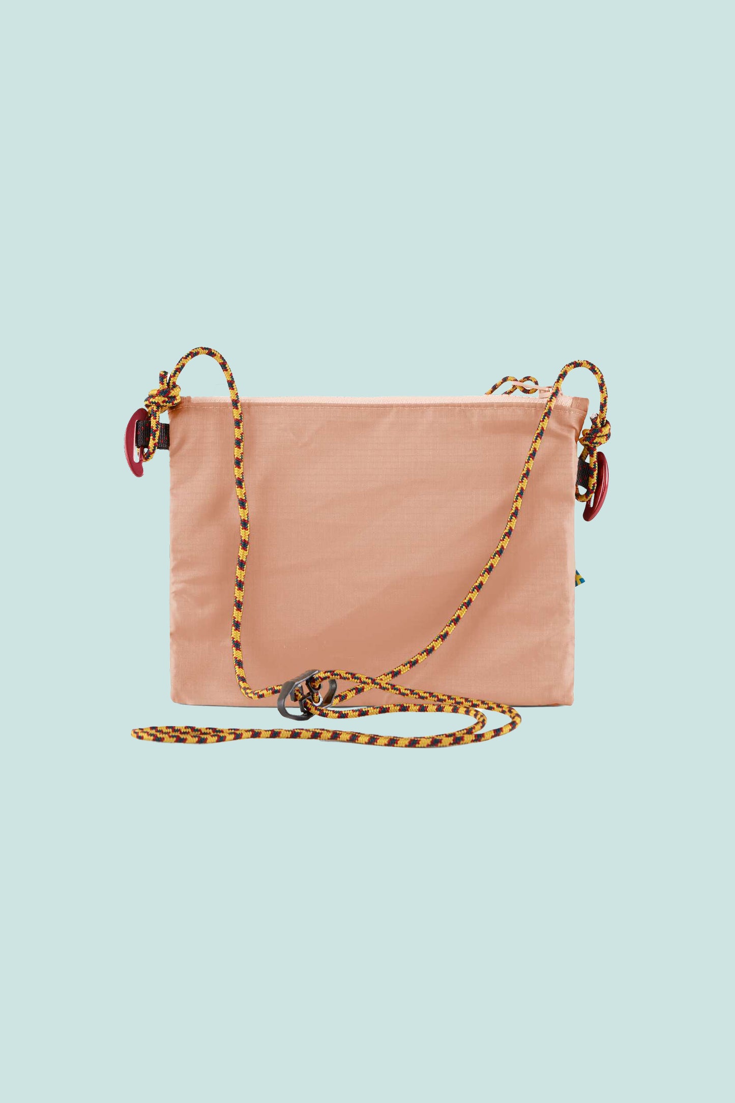 Klattermusen Algir Accessory Bag Small in Salmon color with adjustable strap and mesh pocket.