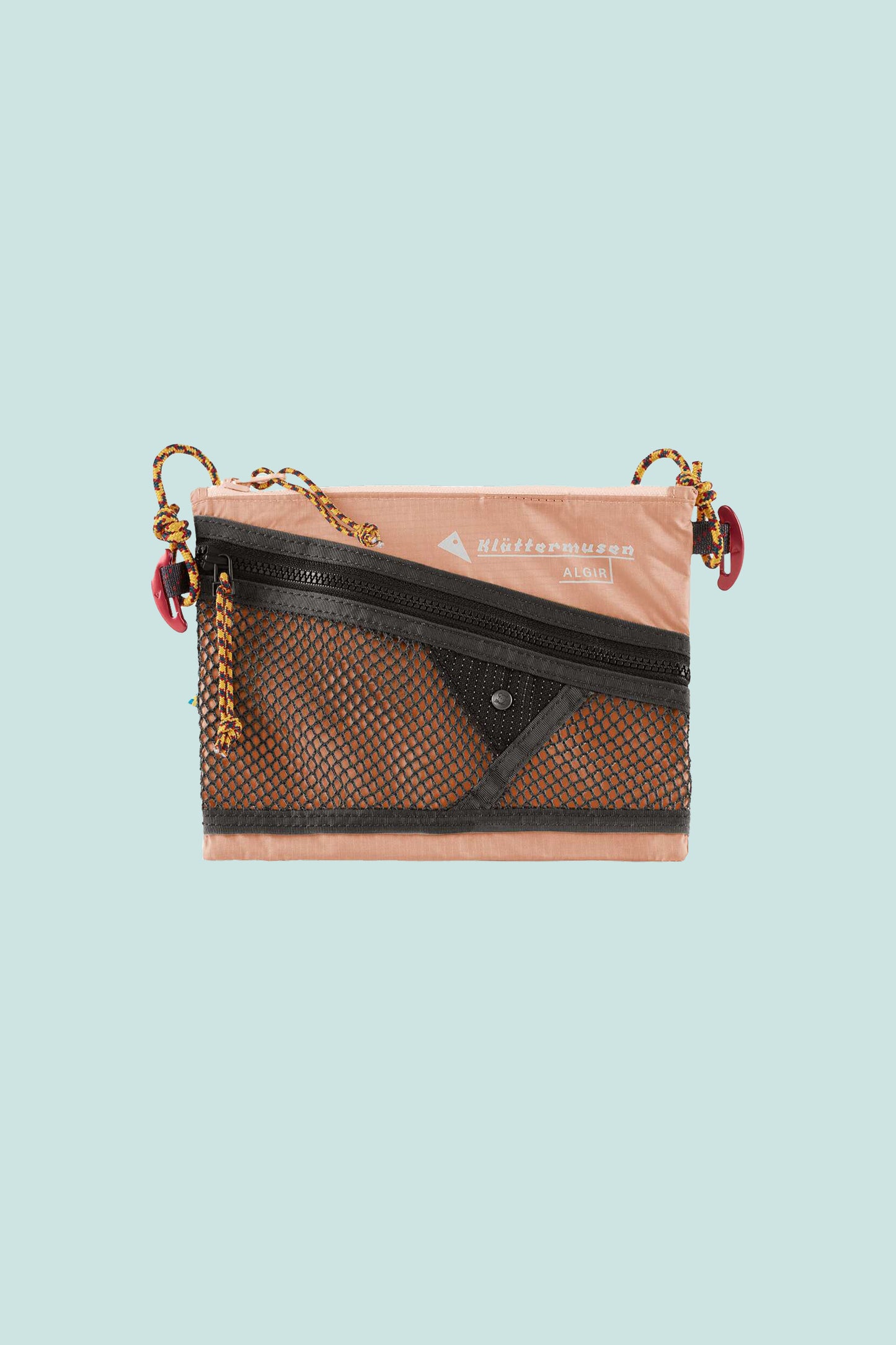 Klattermusen Algir Accessory Bag Small in salmon color with external mesh pocket and adjustable strap.