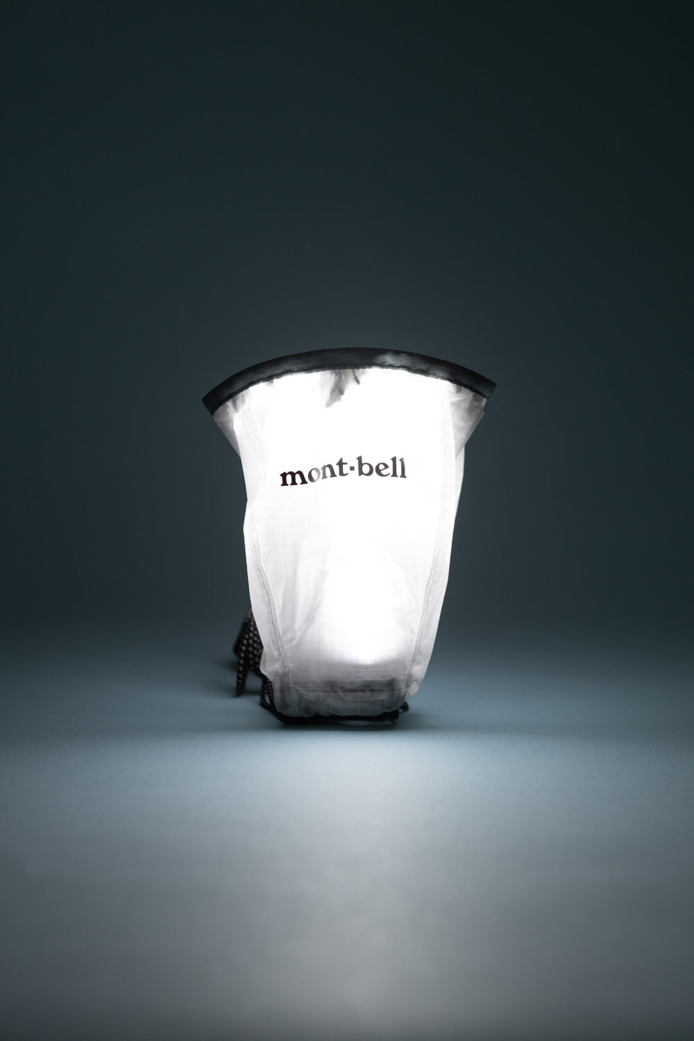 Montbell Crushable Lantern Shade illuminating a compact area, designed for backcountry camping ambience.