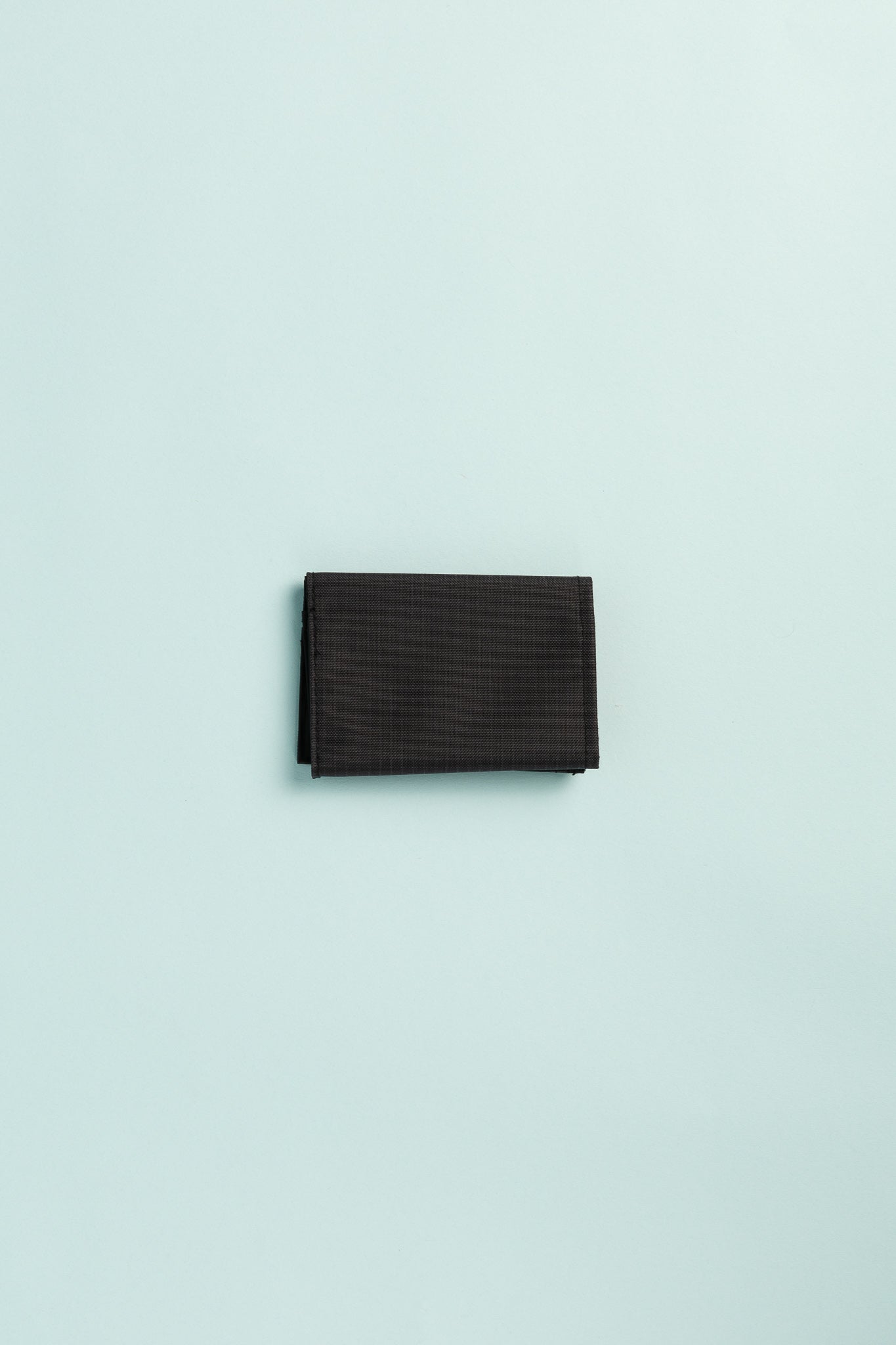 Montbell Trail Wallet in black, compact and lightweight, perfect for outdoor adventures and daily use.