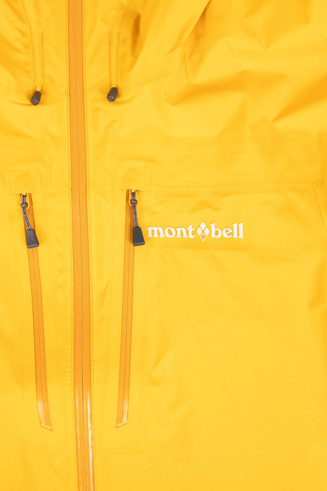 Montbell US Men's Tempest Jacket - Orange close-up showing pockets and zipper details.