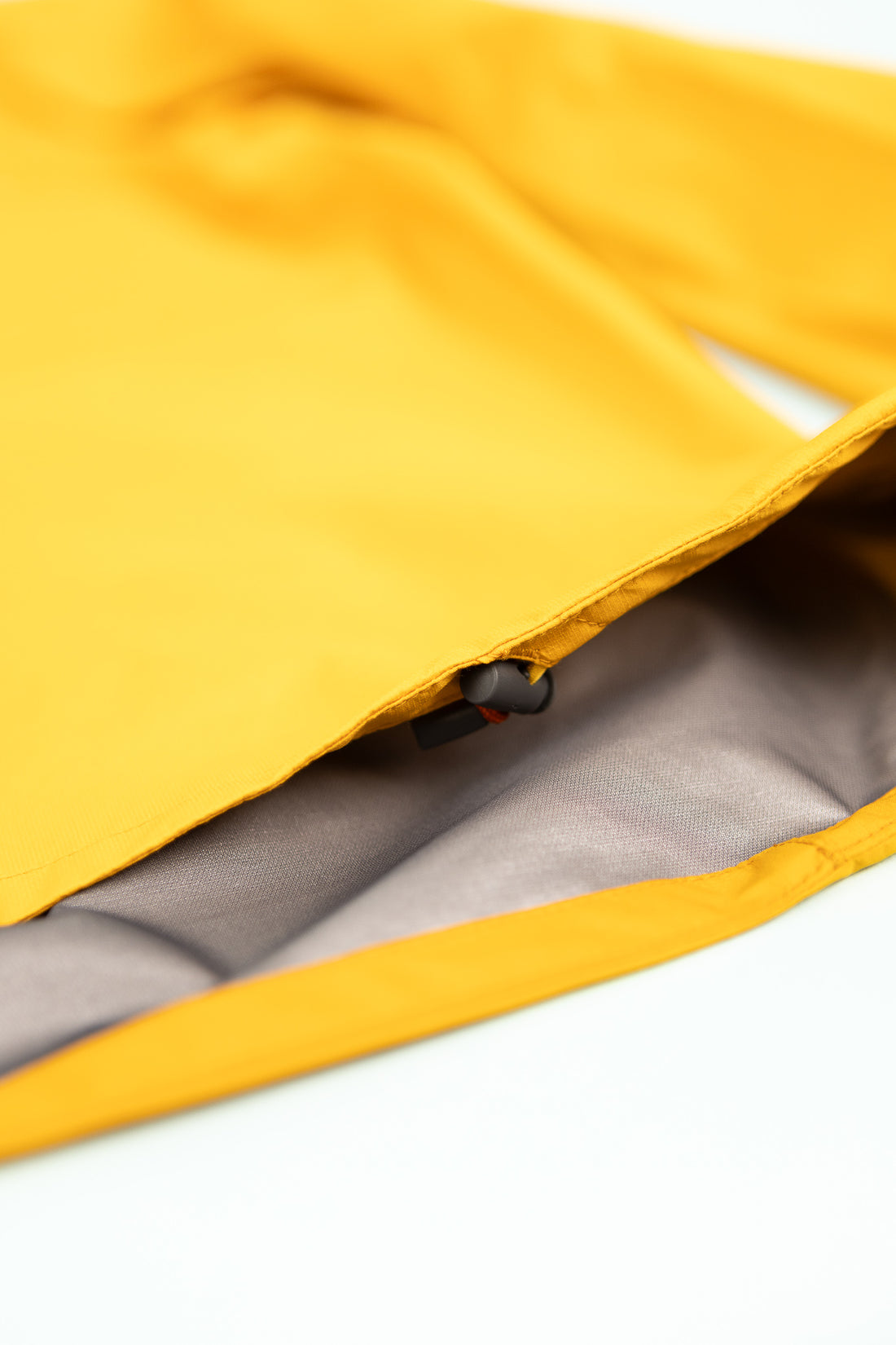 Close-up of the interior lining of the Montbell US Men's Tempest Jacket in orange.