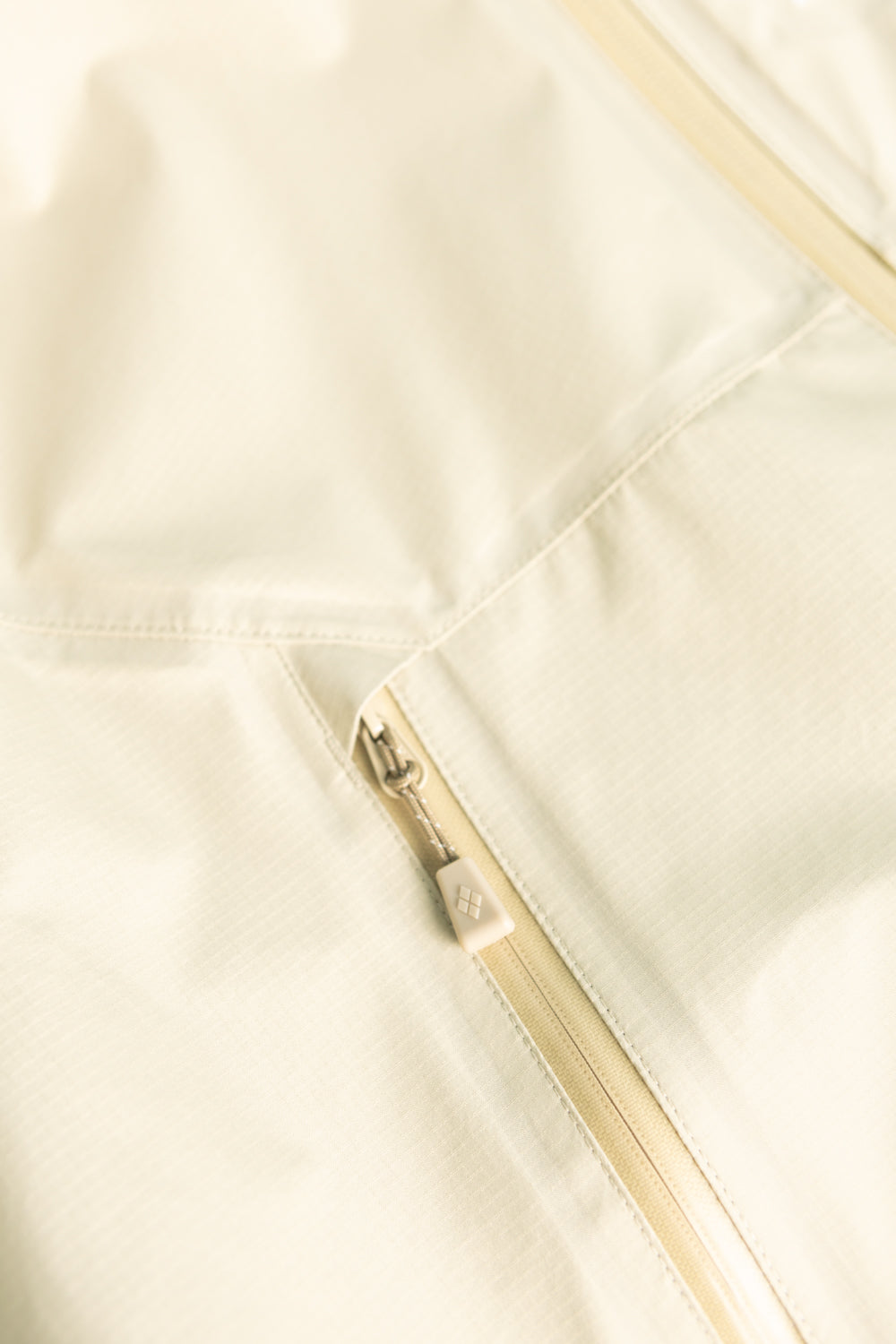 Montbell US Women's Rain Trekker Jacket - Ivory close-up of zipper detail