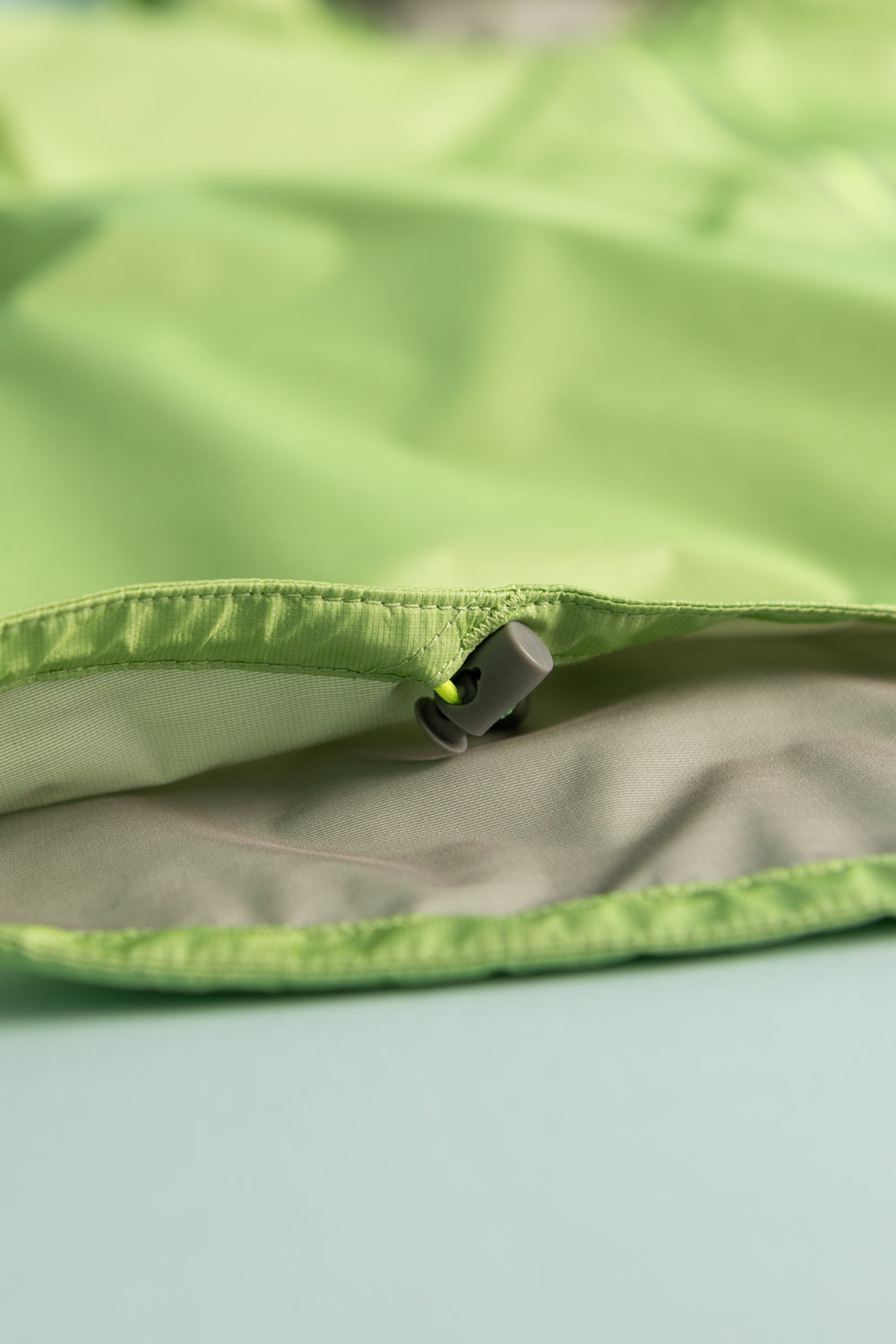 Montbell US Women's Versalite Jacket - Light Green detail featuring the lightweight fabric and adjustable closure.