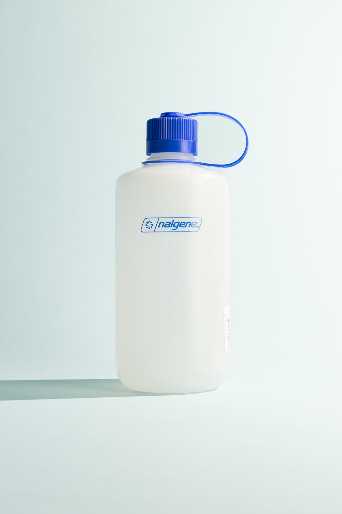 Ultralite N/M 1L water bottle with blue cap, lightweight and durable, ideal for hiking and outdoor activities.