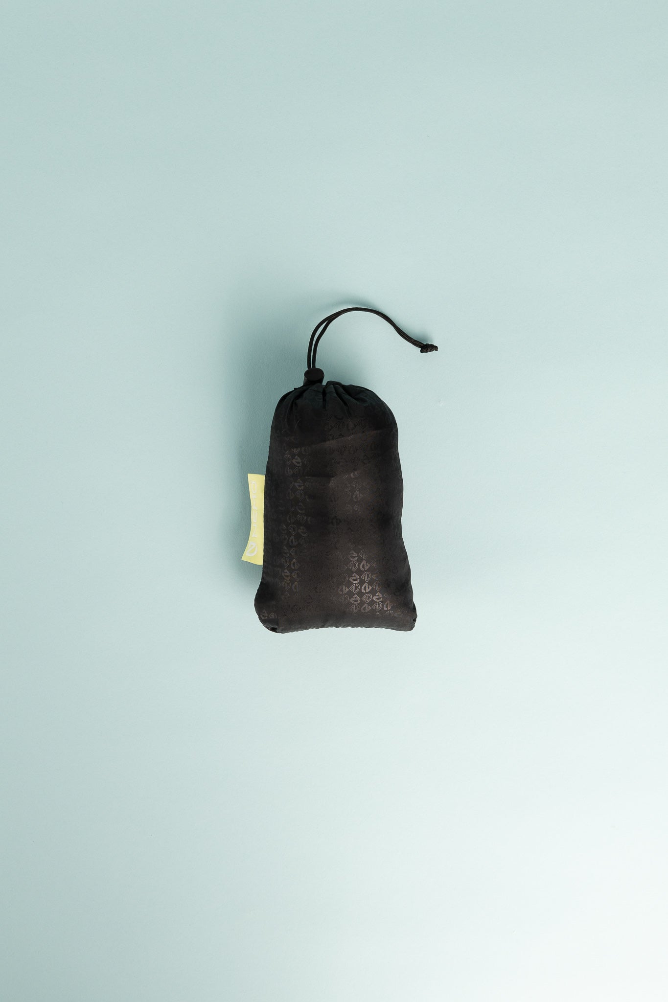 Nemo Fillo Elite Wide Pillow - Black Pearl packed in a sleek, lightweight carrying pouch on a light blue background.