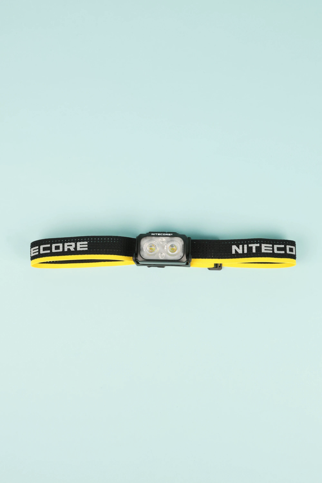 Nitecore NU25 MCT 400L - Yellow headlamp with adjustable elastic band on blue background.