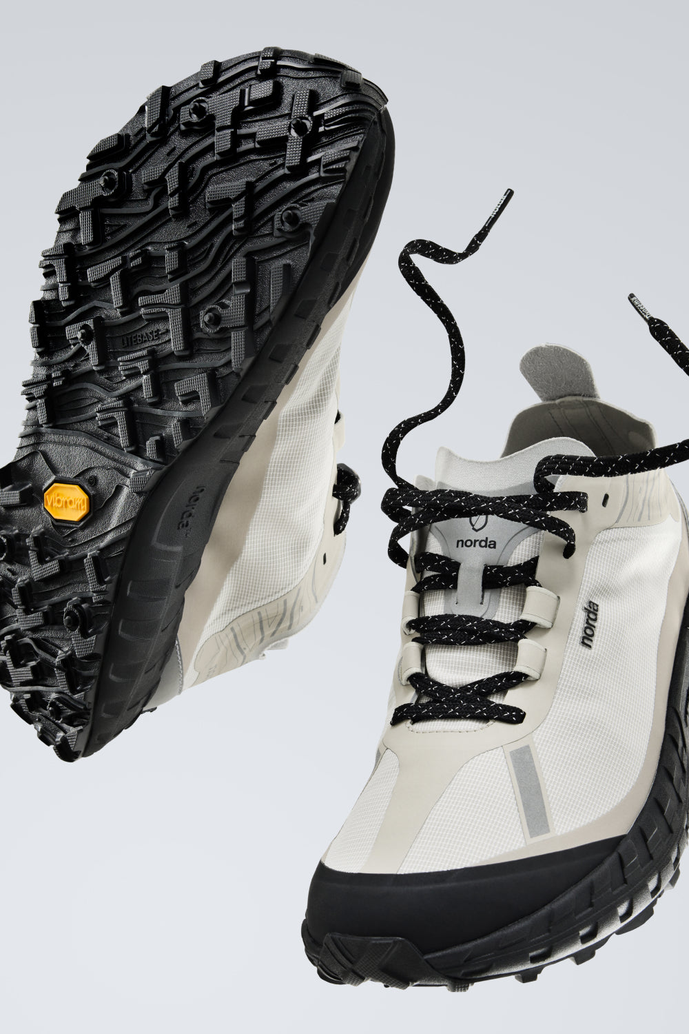 Norda 001A - Cinder trail running shoes showcasing Arnitel® TPEE® midsole technology and Vibram outsole.
