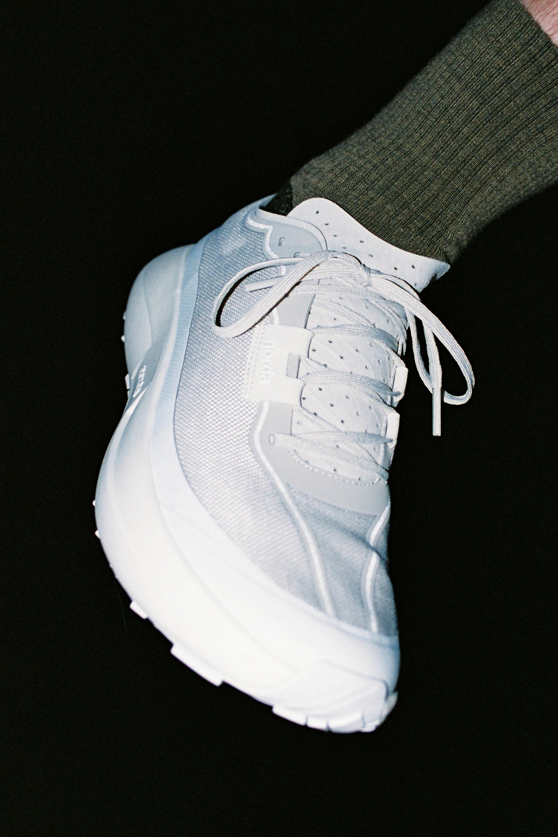 Norda 005 - Névé trail shoe shown on foot, designed for stability and speed on technical terrains.