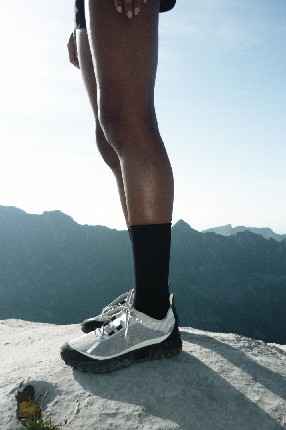 Norda 001A - Pewter trail shoe on a hiker's foot, showcasing performance and modern design in nature.