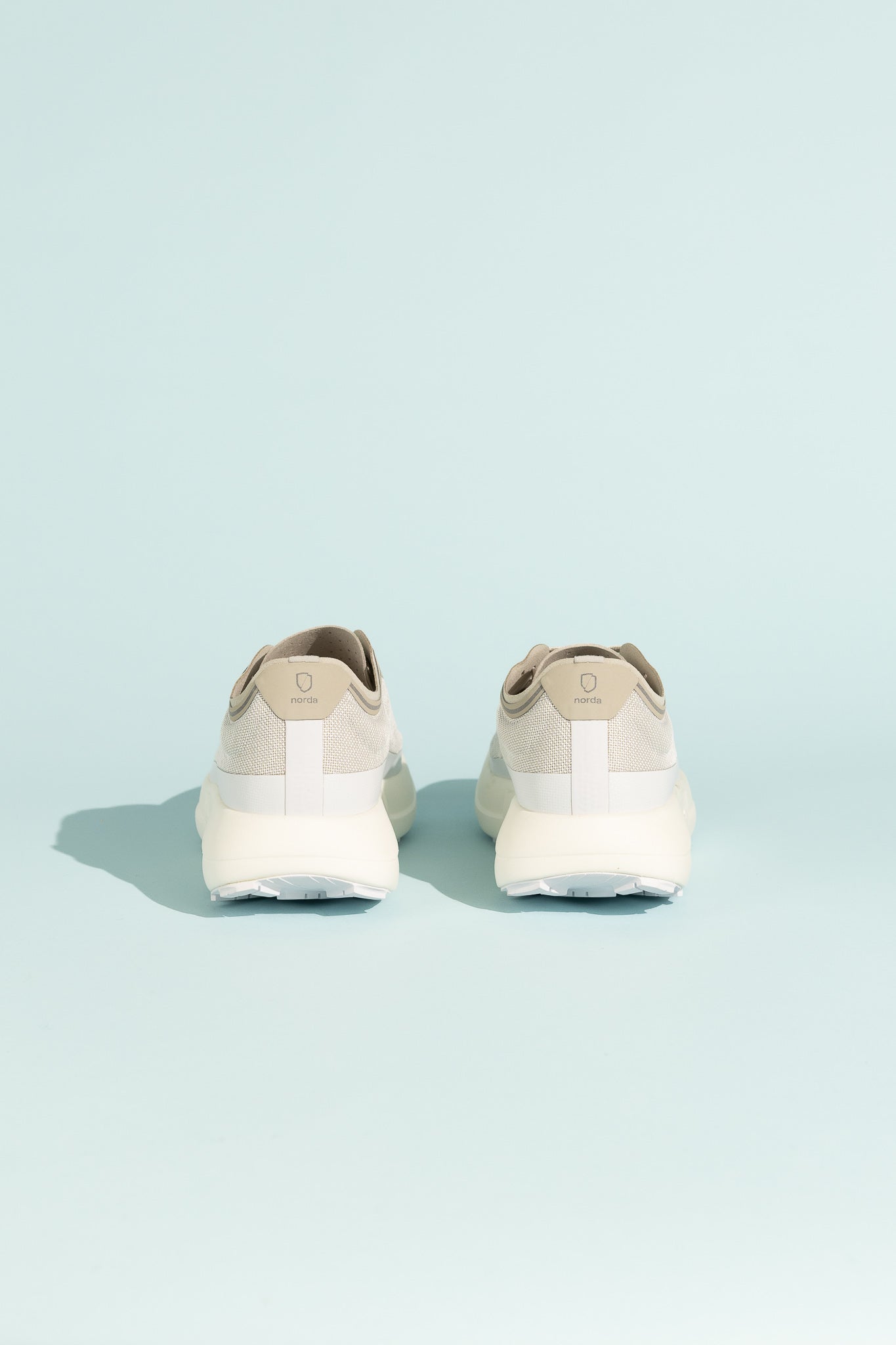 Back view of the Norda 005 - Névé trail shoes showcasing lightweight design and stability features.