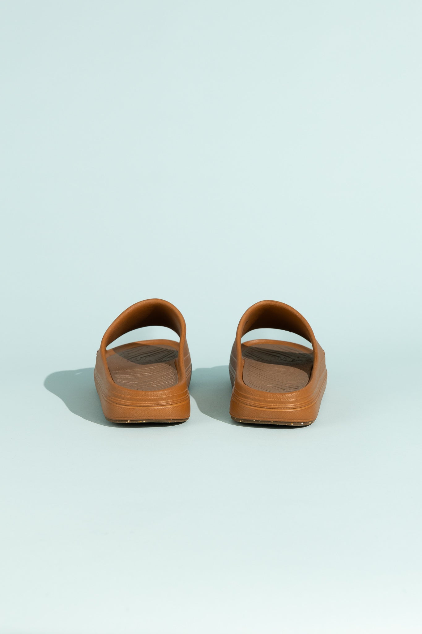 Norda 008 - Oud back view of premium recovery slides in brown color against a light blue background.