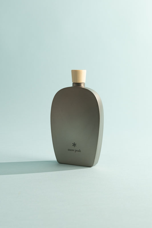 Snow Peak 250ml Titanium Flask with wooden cap on a light background