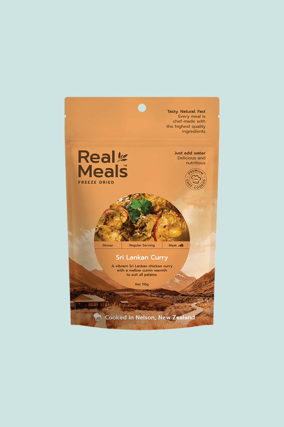 Real Meals Sri Lankan Curry packaging featuring vibrant chicken curry on a scenic background.