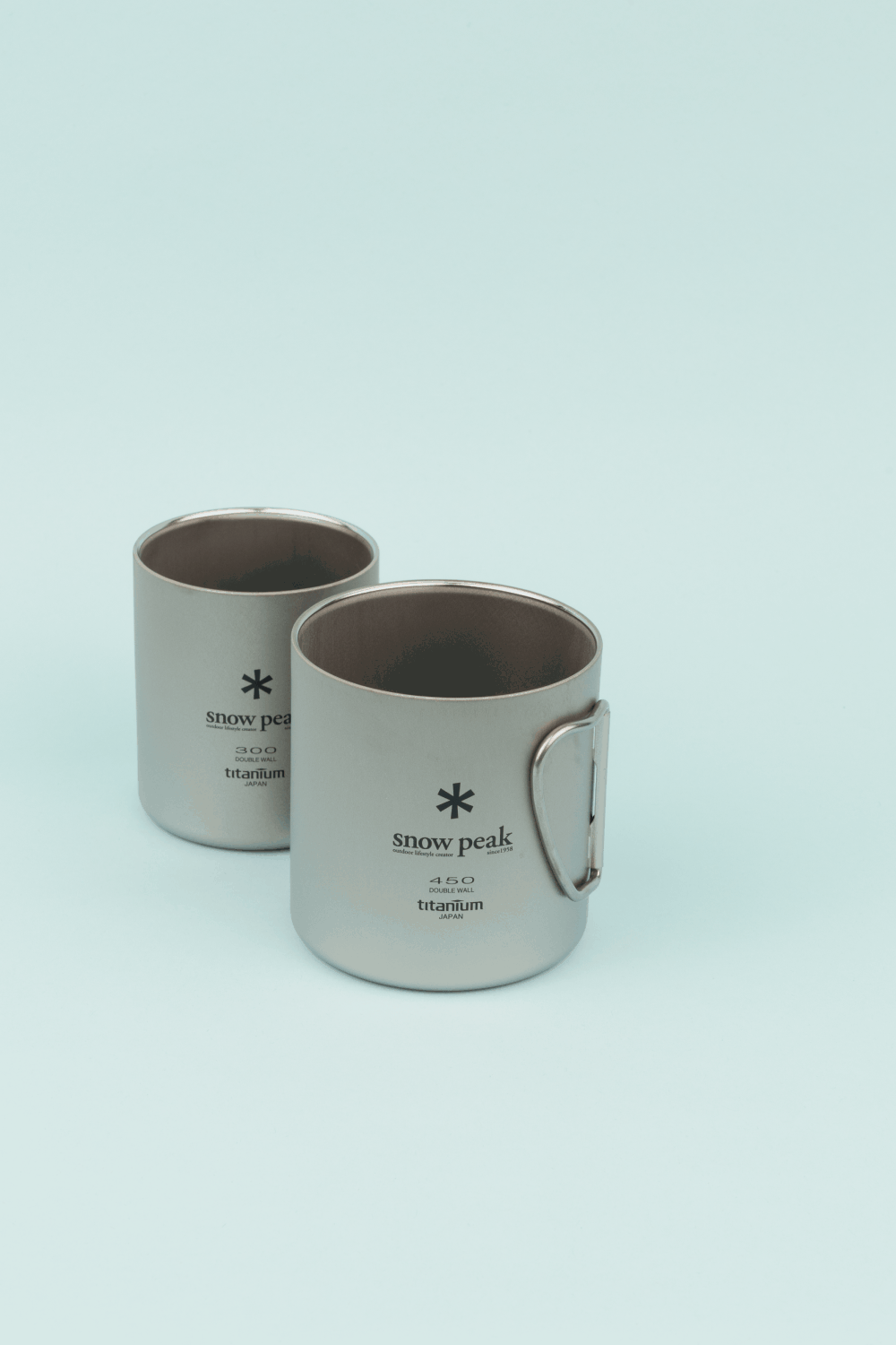 Snow Peak Double Wall Titanium Nesting Cup Set featuring two durable titanium mugs for outdoor adventures.