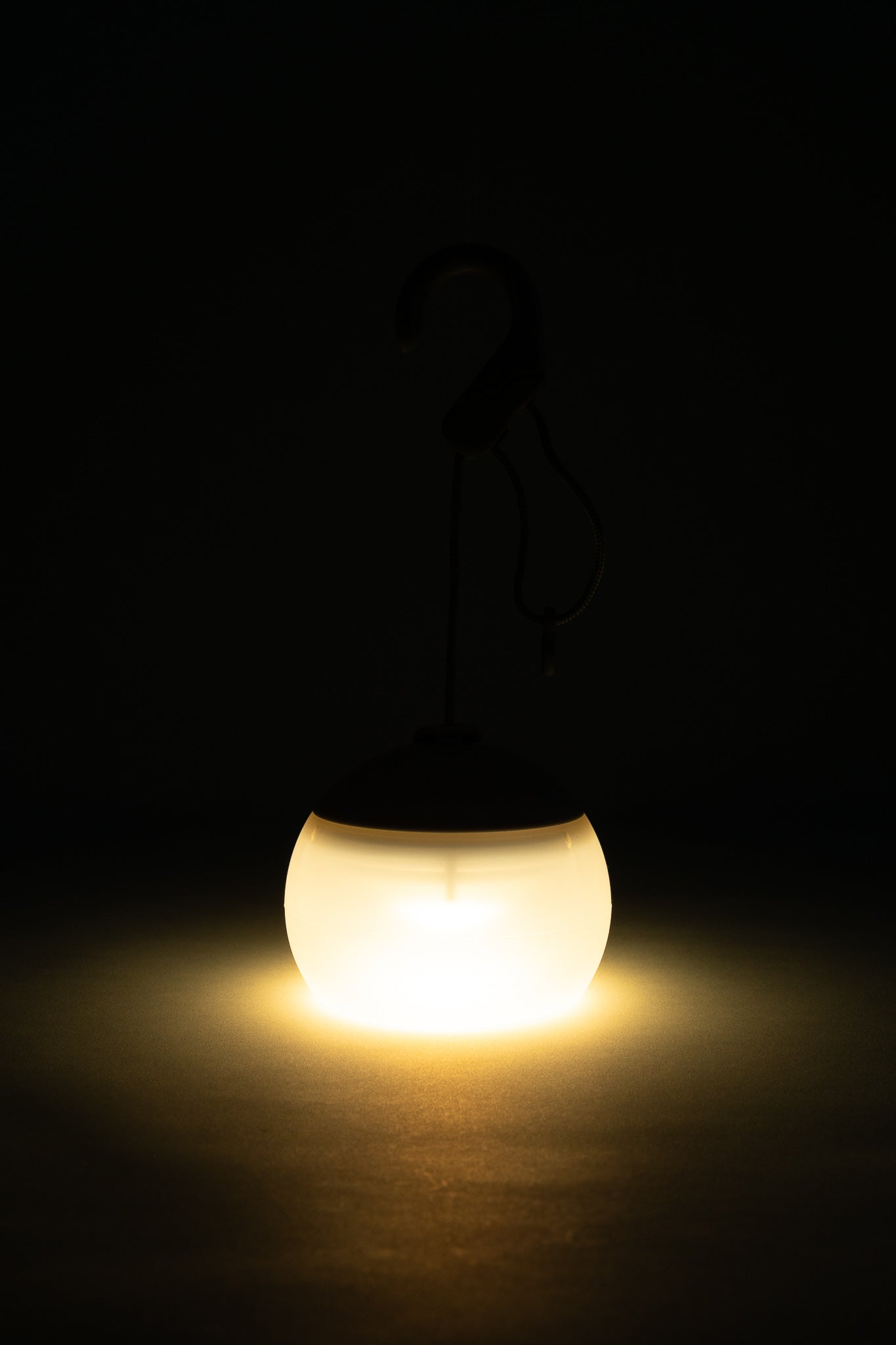 Snow Peak Rechargeable Hozuki Lantern - Morning Mist illuminating a dark space with soft light.