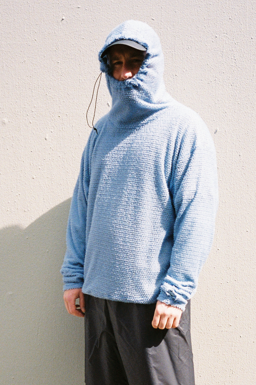 Shag Hoodie v2.0 in blue color worn by a person, showcasing its unique boxy fit and cozy design.