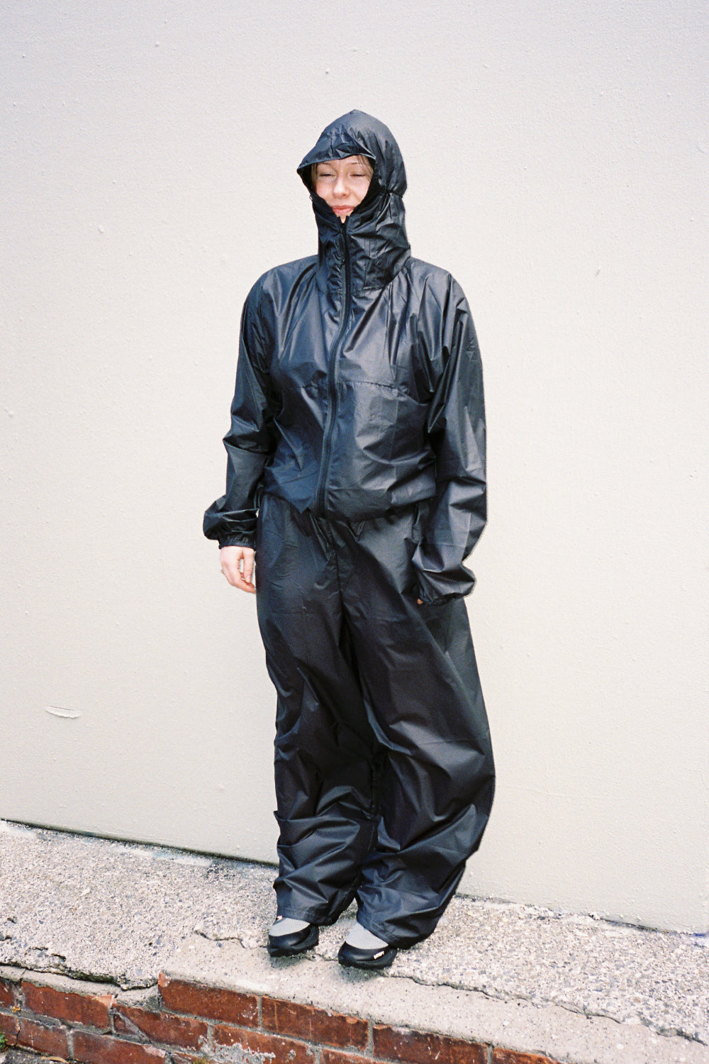 Model wearing Breaker Wind pants in black, showcasing lightweight and durable design for weather protection.