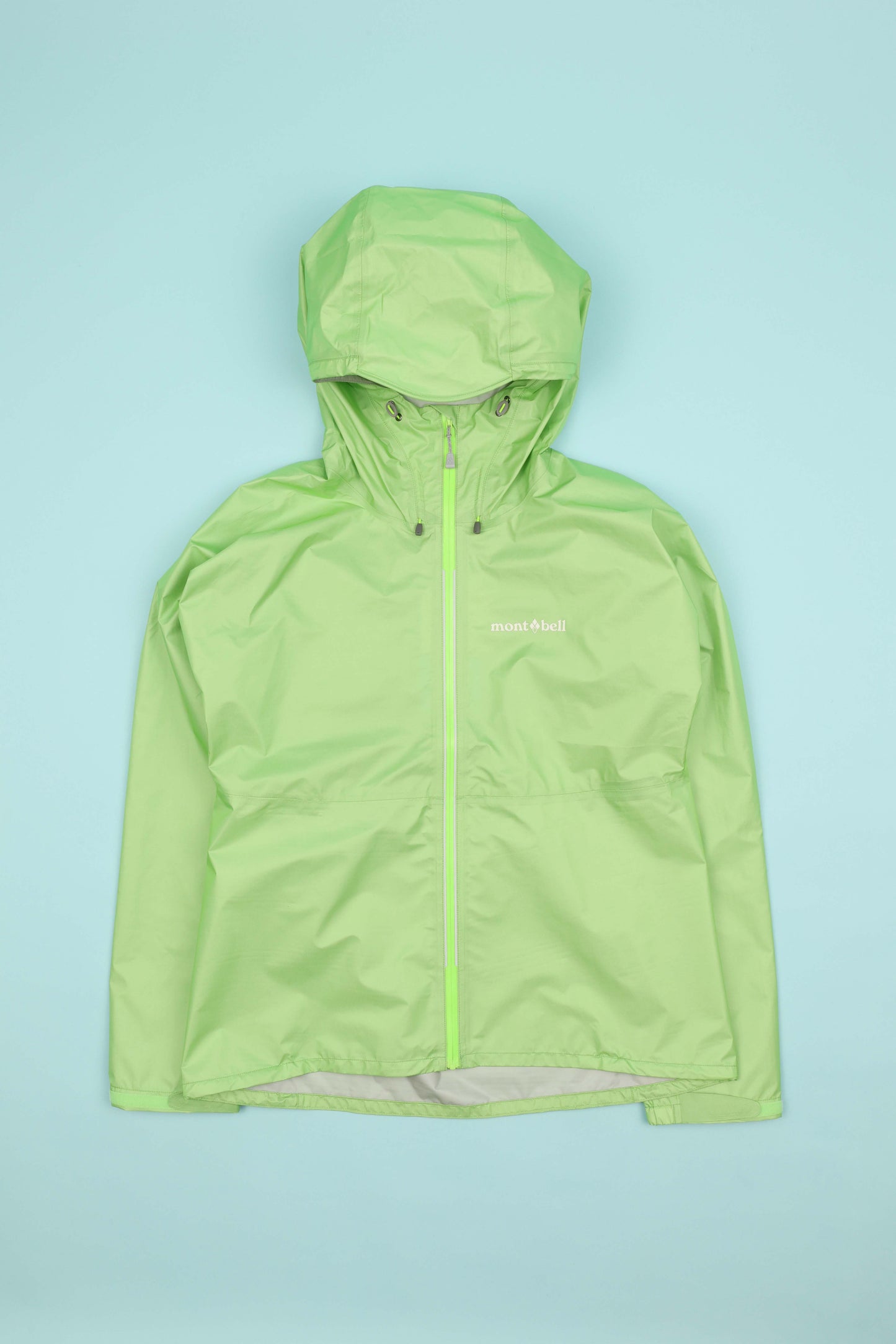 Montbell Womens Versalite Jacket - Light Green on a light blue background