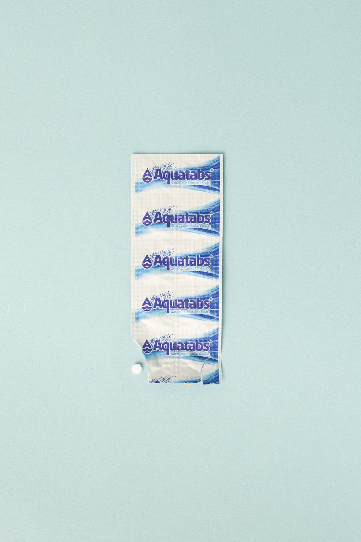 Aquatabs Purification Tablets pack with five tablets on a light blue background