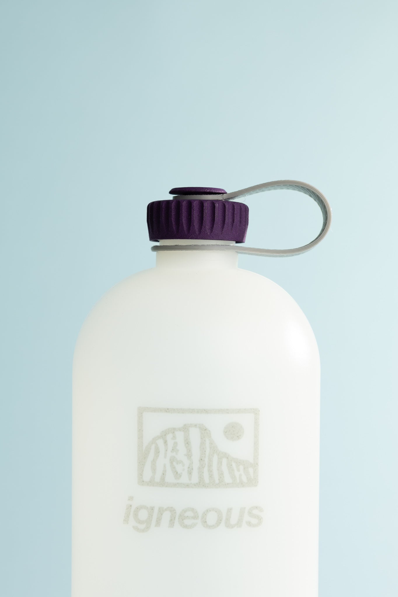Igneous Gear NOBO Bottle with purple cap against a blue background, ideal for ultralight hiking or daily use.