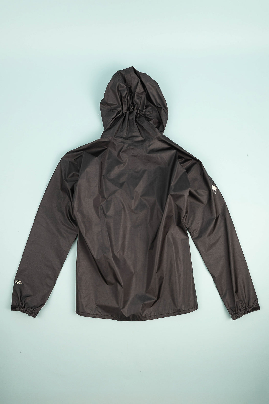 US Men's Versalite Jacket - Black, back view showing hood and lightweight fabric.