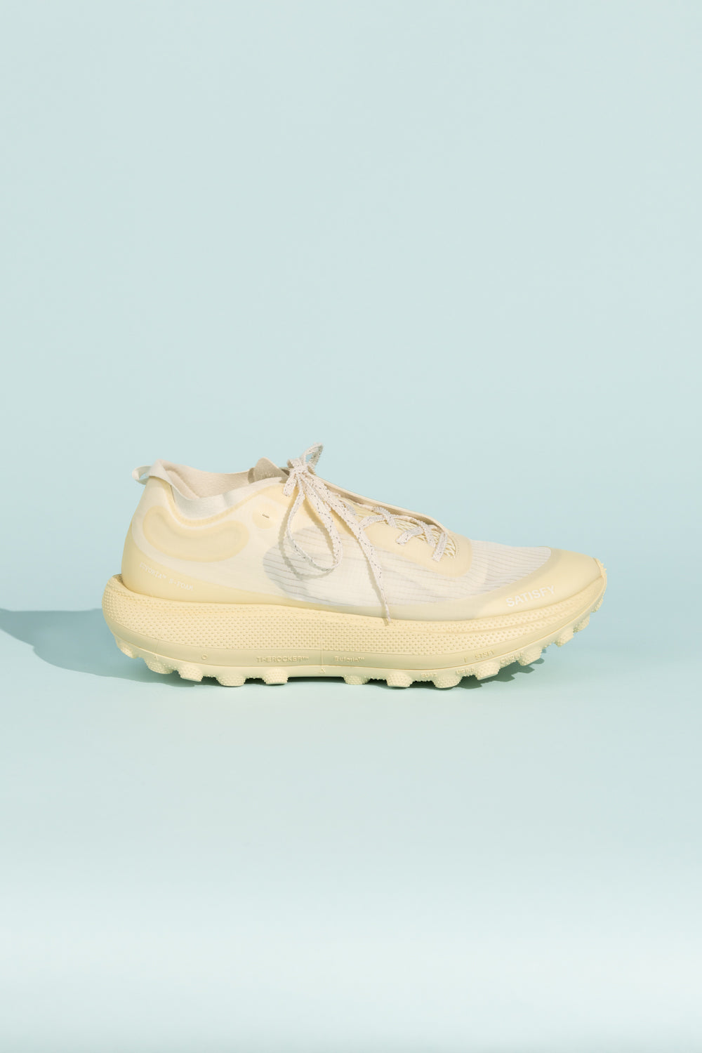 Satisfy TheROCKER - Antique White sneaker side view on a light blue background