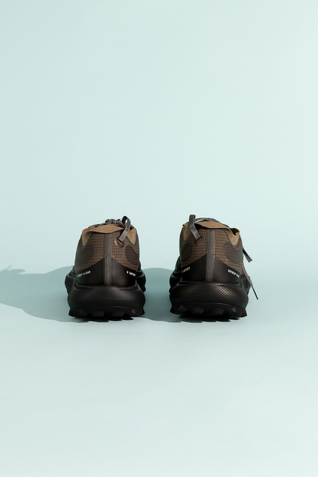 Back view of Satisfy TheROCKER shoes showcasing the camo design and rugged sole for ultra-distance performance.