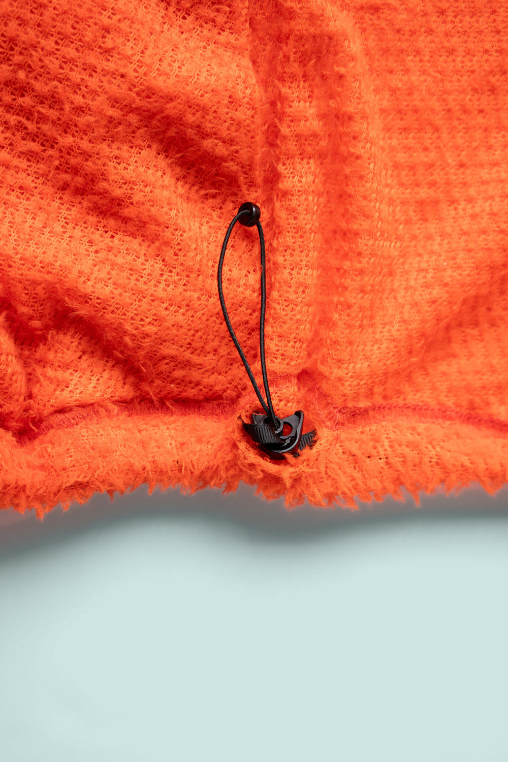Shag Hoodie v2.0 in Tangerine Tango, drawcord hem detail