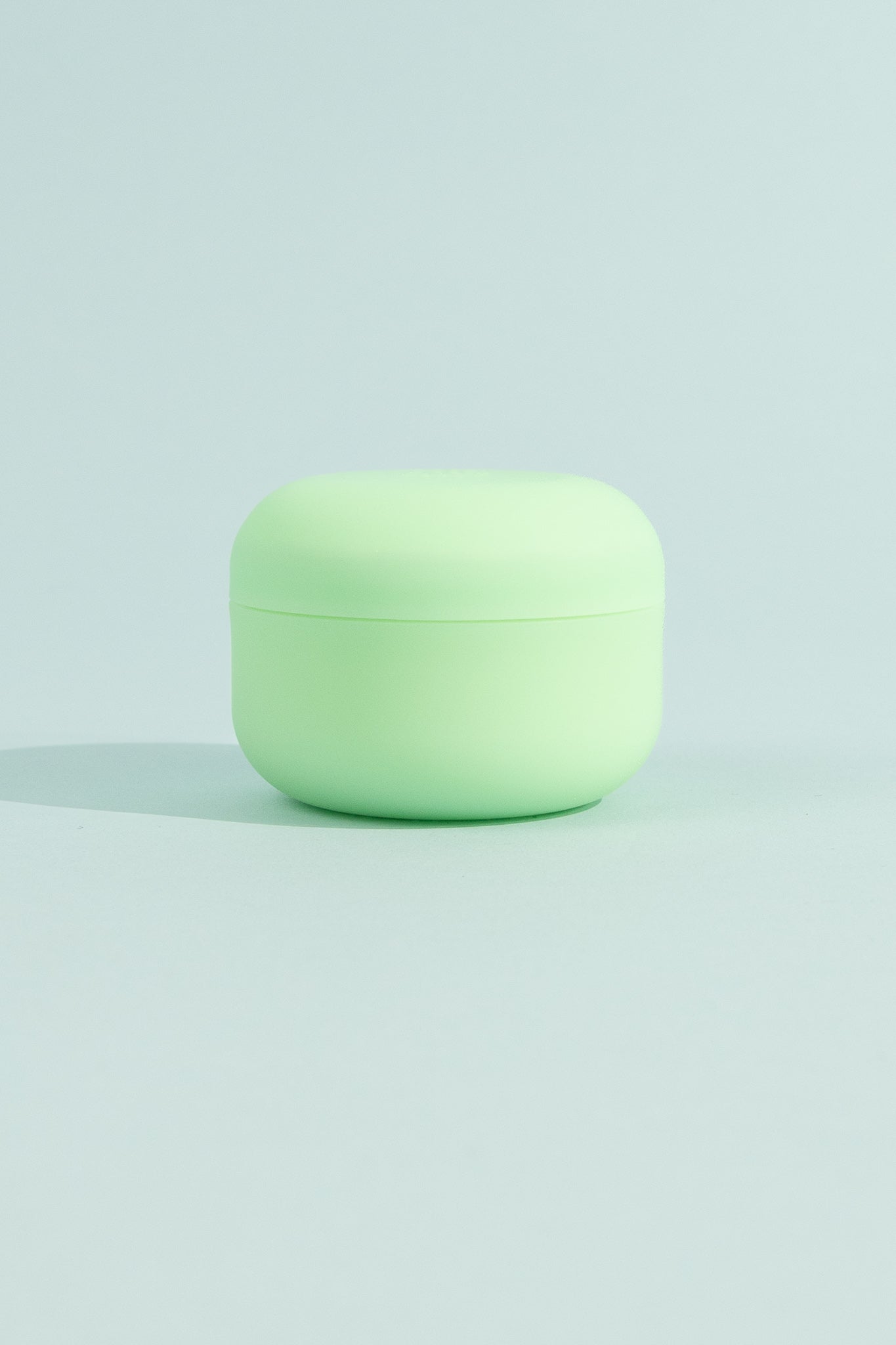 OEM Soothing Cream in a green jar on a light background for deep muscle relief and rejuvenation.
