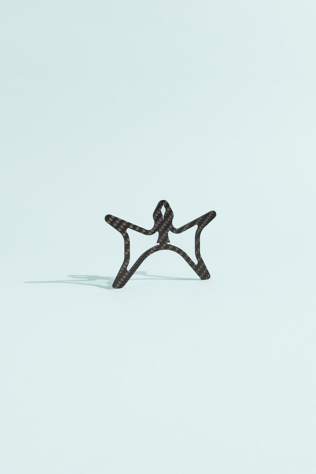 Carbon Cord Spool designed for organizing cords while backpacking, lightweight and compact.