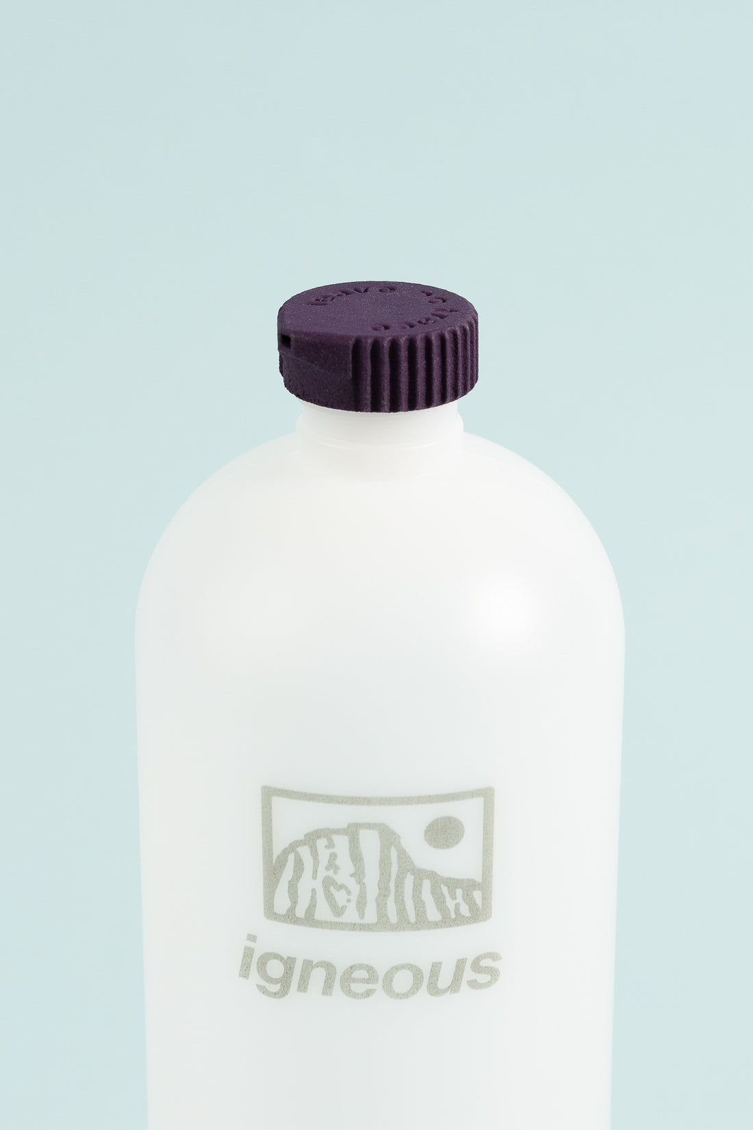 Bottle Cap Bidet attached to an Igneous water bottle, showcasing the amethyst cap for outdoor hygiene and convenience.