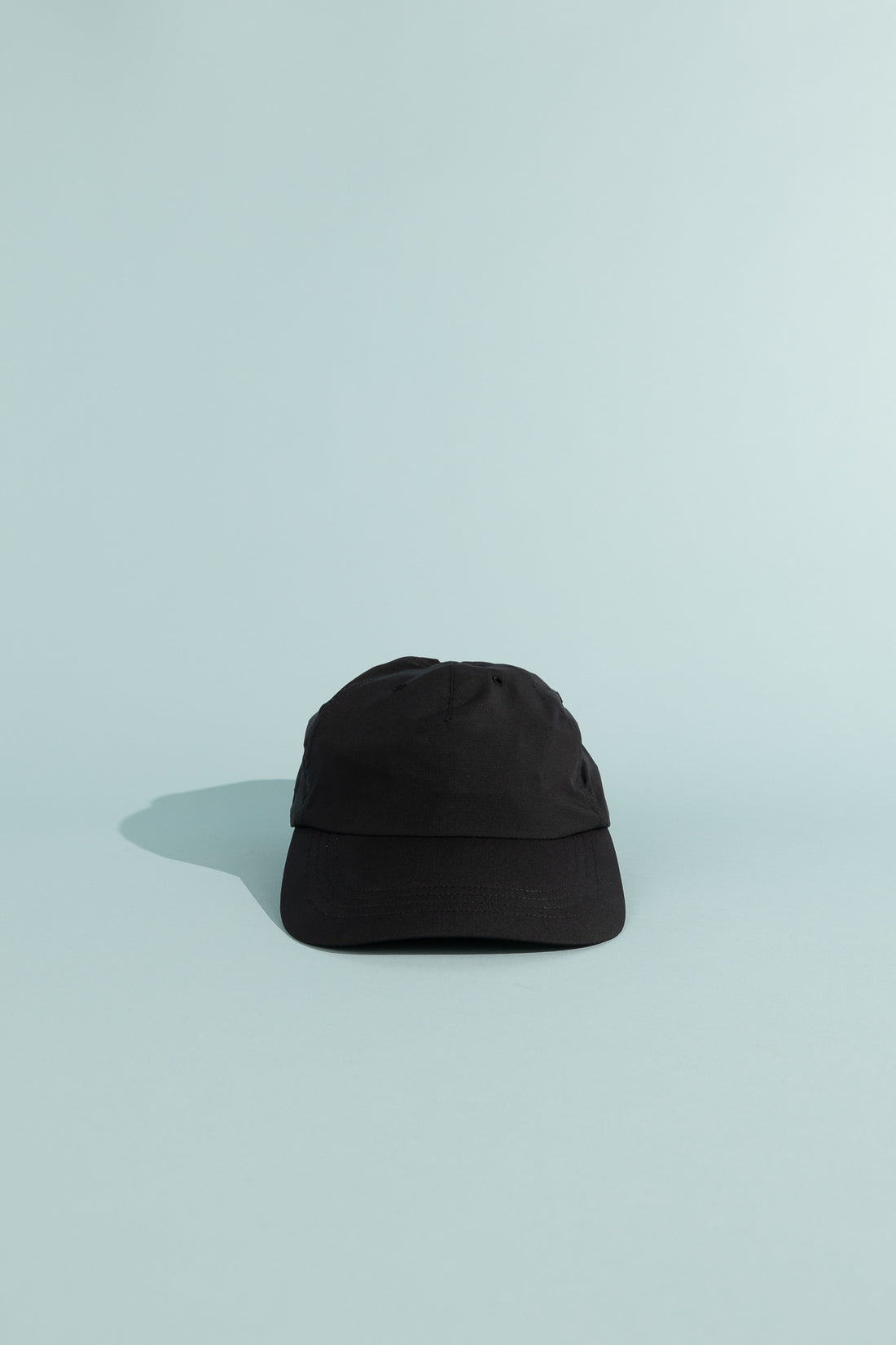 C9 Cap - True Black on a light background, featuring a lightweight and breathable design for outdoor activities.