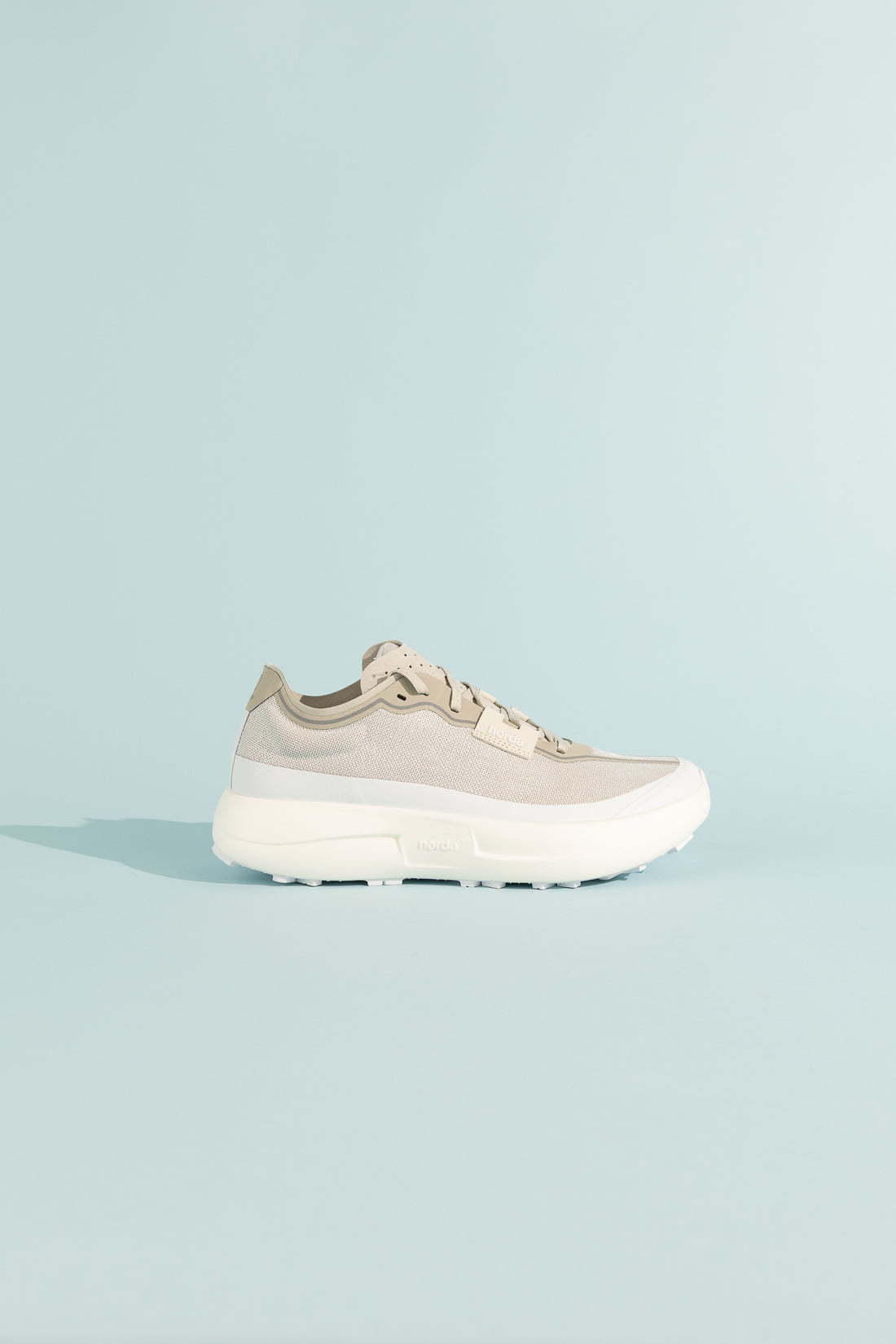 005 - Névé lightweight and stable trail shoe in beige, designed for optimal performance on hard, flat terrains.