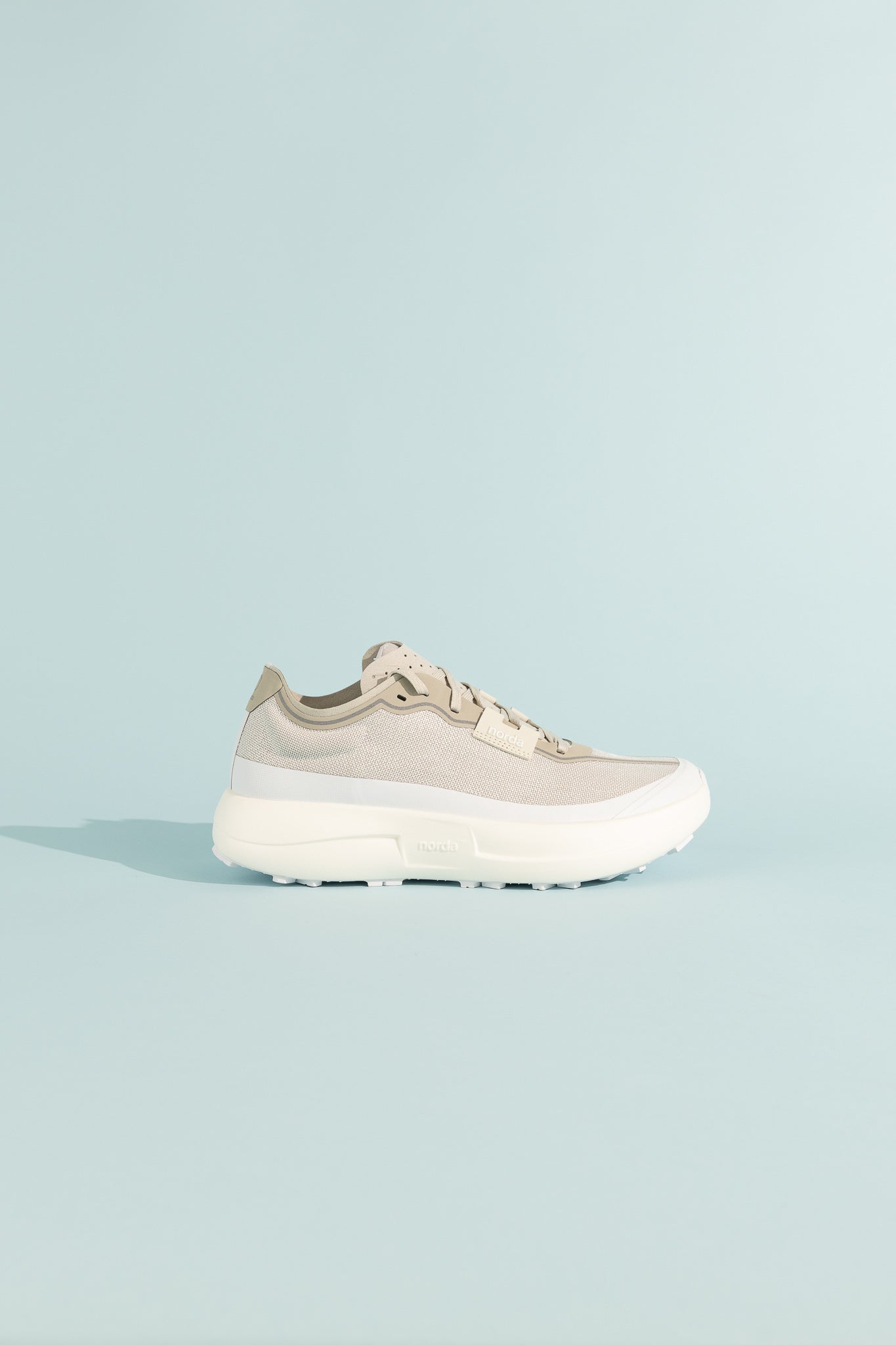 005 - Névé lightweight and stable trail shoe in beige, designed for optimal performance on hard, flat terrains.