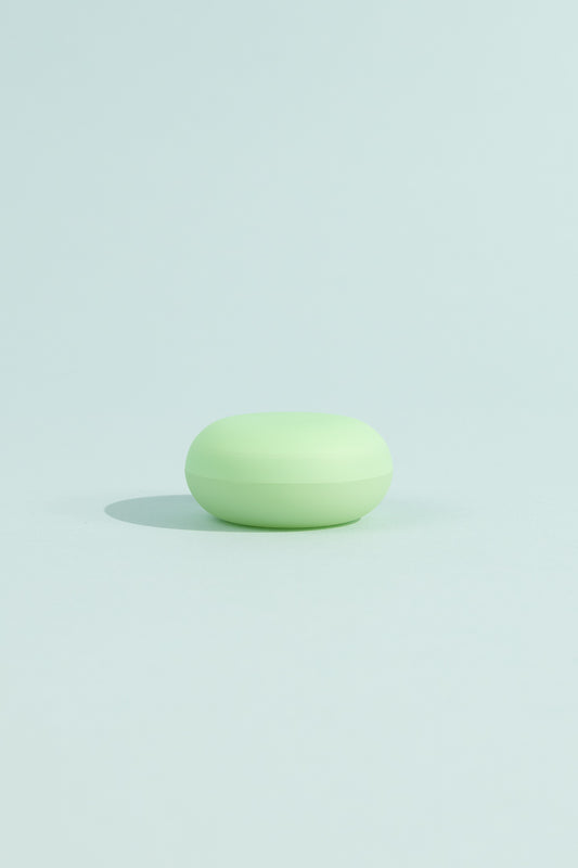 OEM Nourishing Lip Balm - Menthol in a green container on a light blue background.