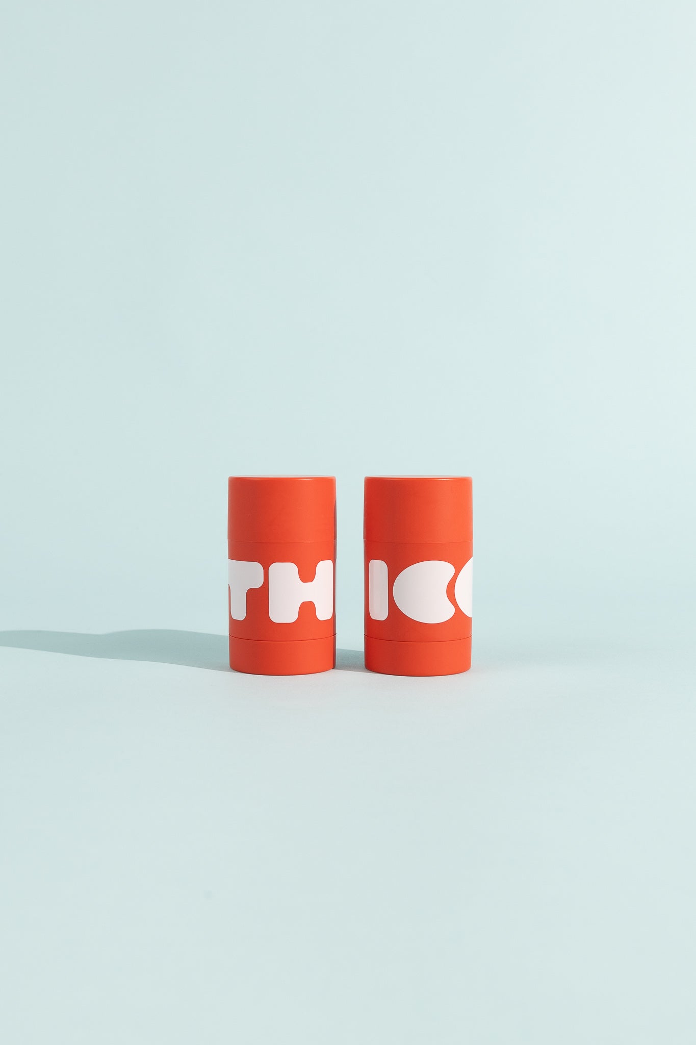 Stick Chafe Balm by THICC - soothing balm in vibrant red containers for friction relief.