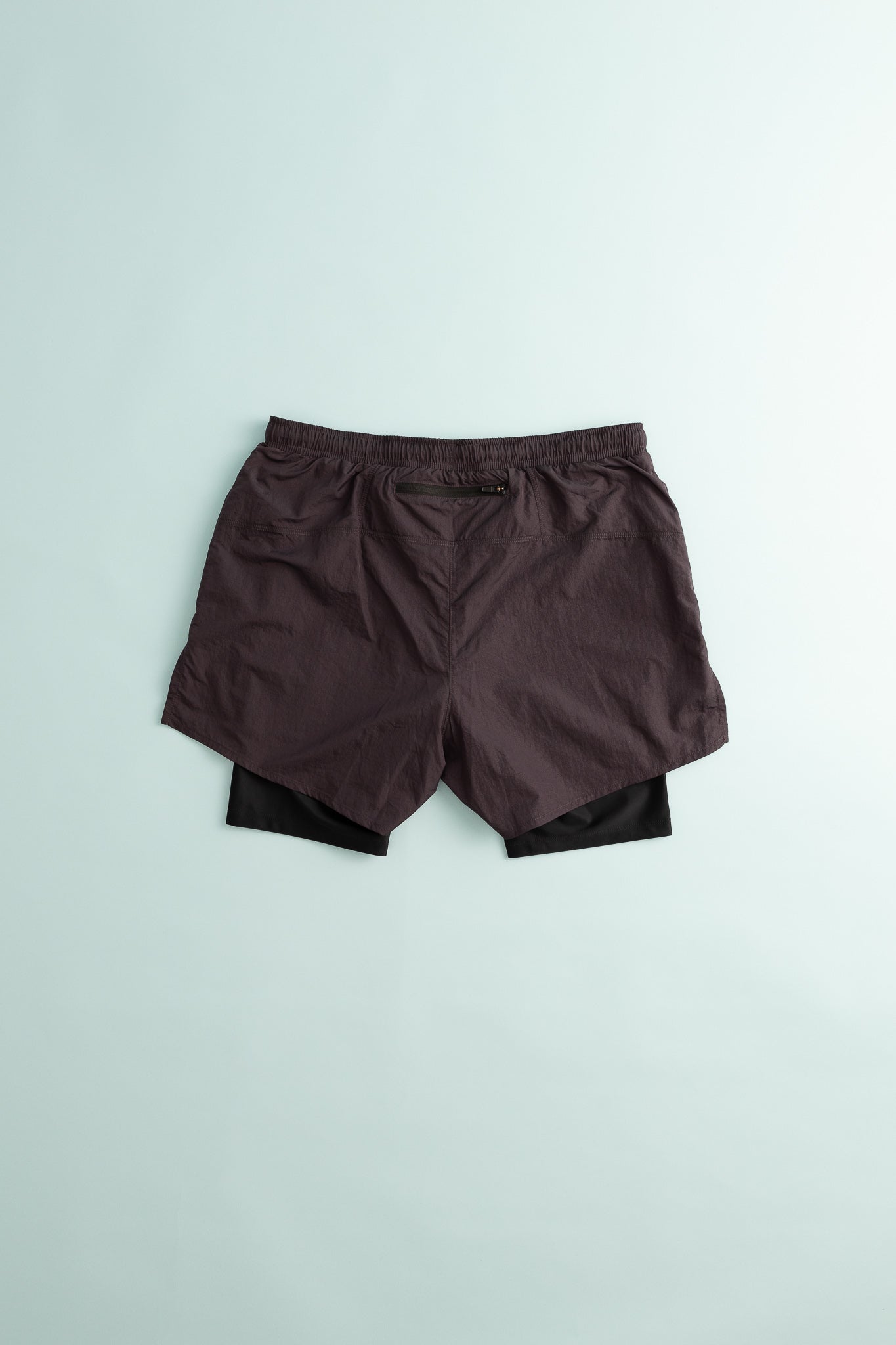 District Vision Mens Ultralight Nylon Trail Shorts showcased from the back on a light background.