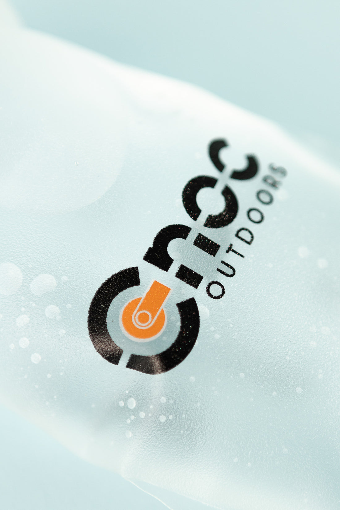 Close-up of Hydriam 350ml Collapsible Flask logo on a frosted surface.