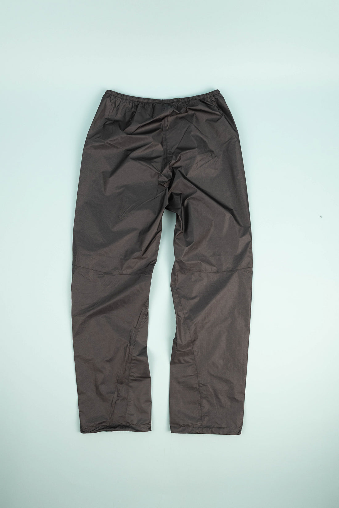 Montbell US Men's Dry-Tec U.L. Rain Pants in black, showcasing the back design and lightweight fabric.