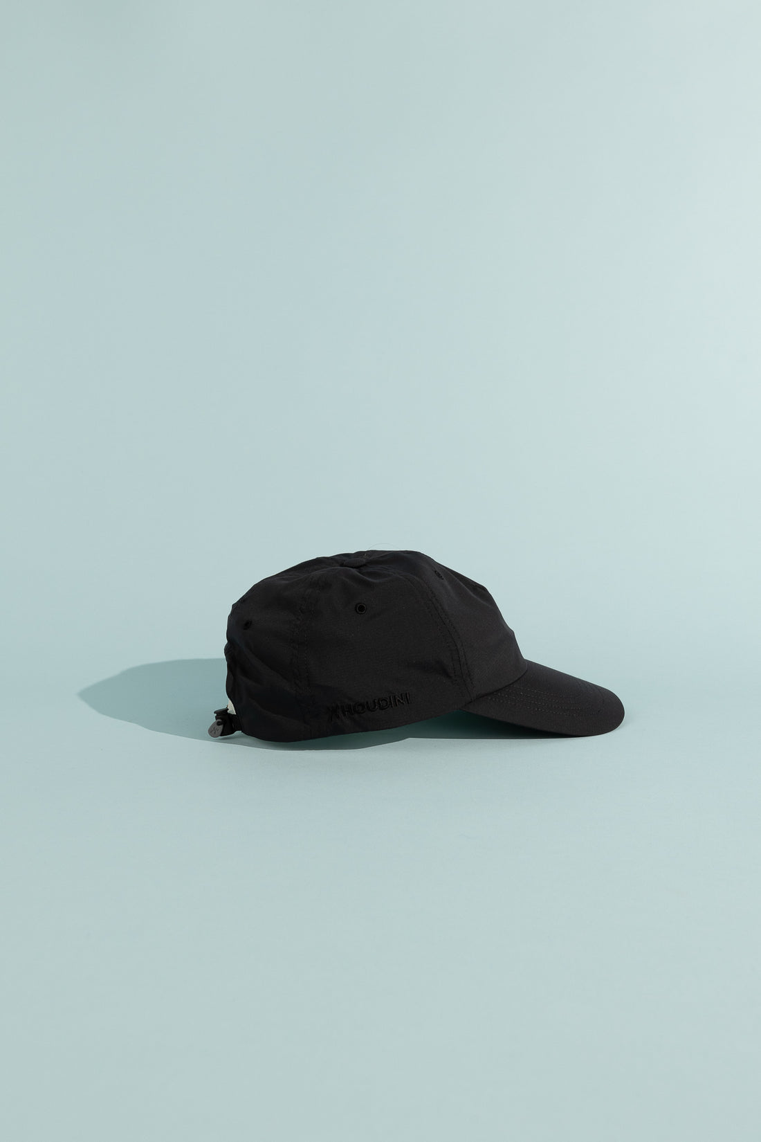 C9 Cap in True Black displayed on a light background, showcasing its lightweight and breathable design.