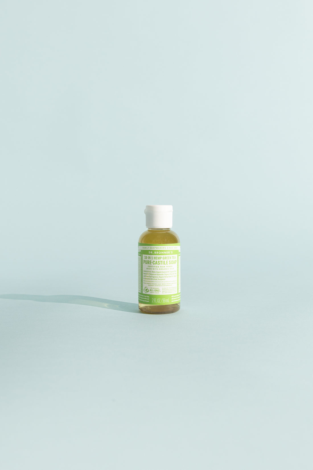 Green Tea Pure-Castile Liquid Soap - 59ml bottle on a soft blue background.