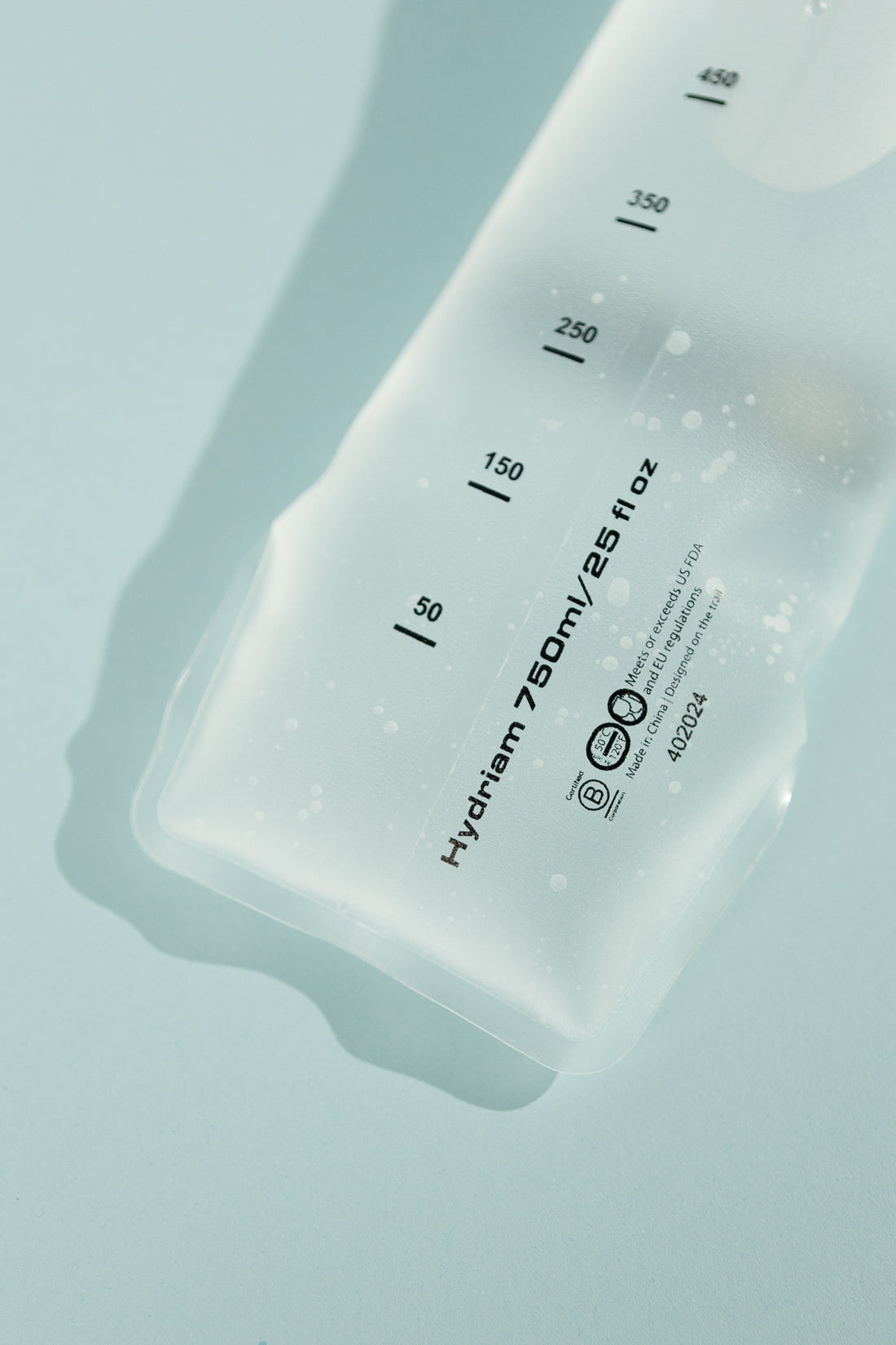 Hydriam 750ml Collapsible Flask with measurement markings on a light blue background
