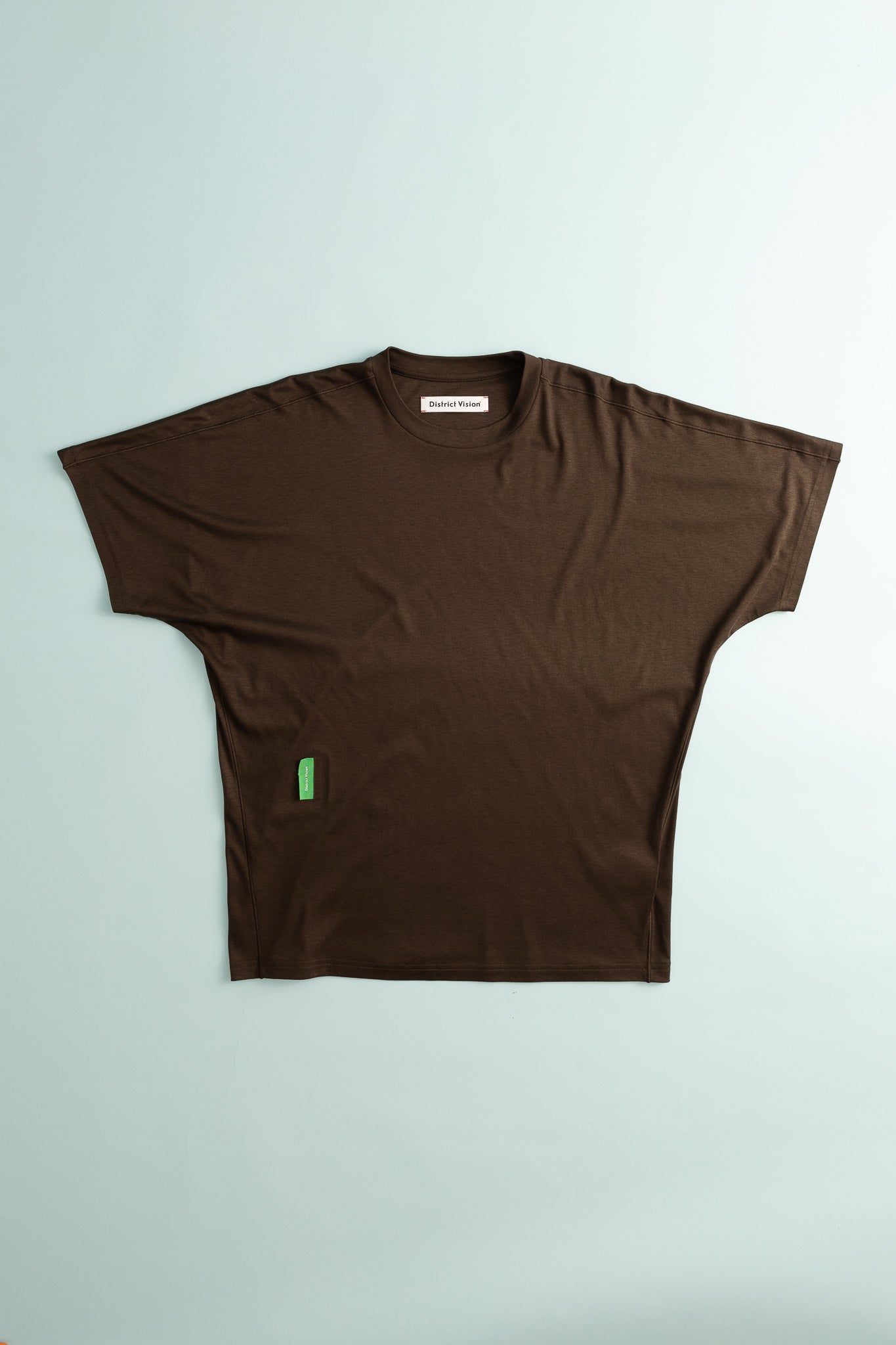 District Vision Dolman Mens Short Sleeve Tee in deep brown color with a casual design on a light background.