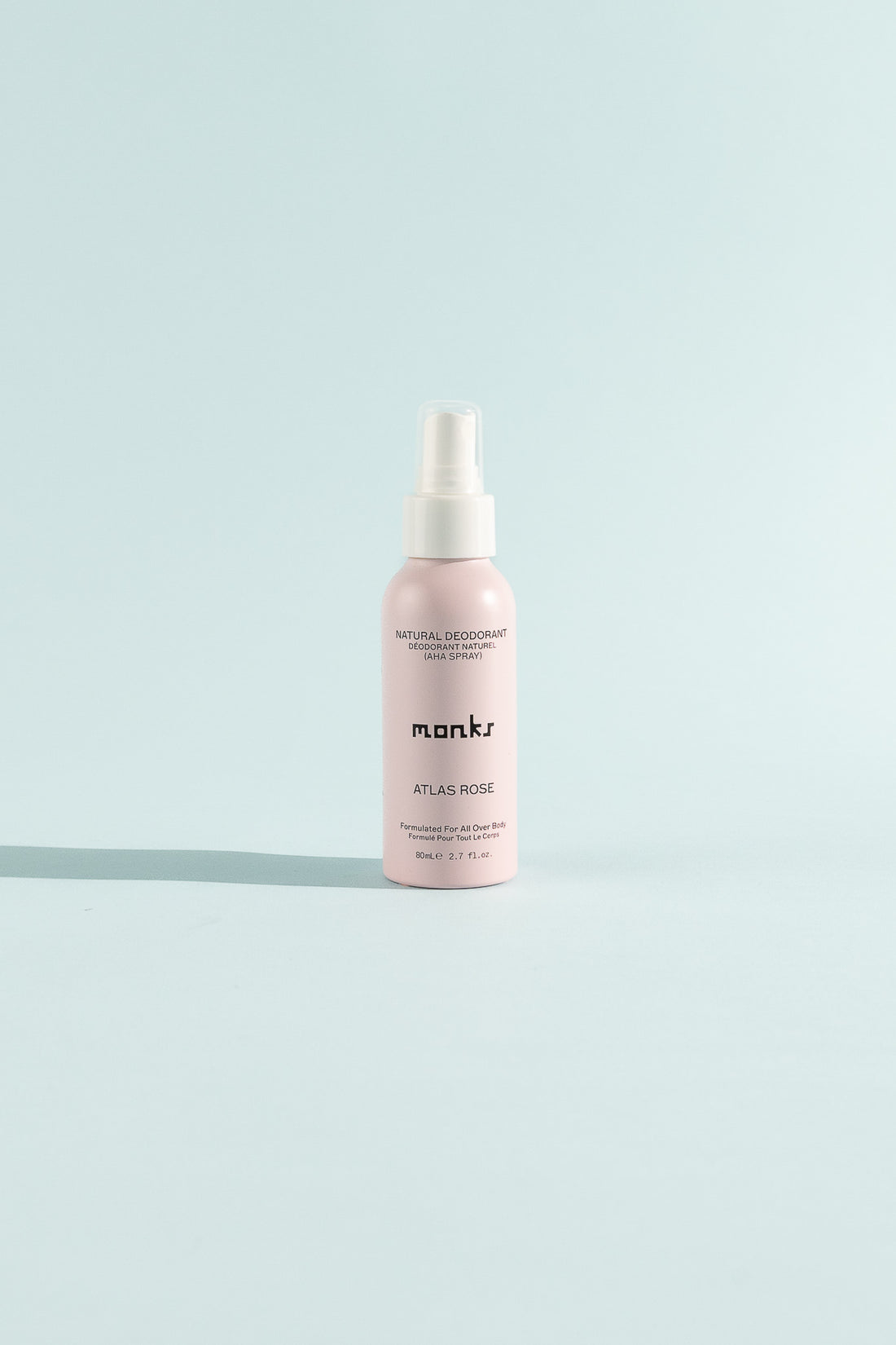 Atlas Rose Spray Deodorant bottle on a light blue background featuring skincare ingredients.