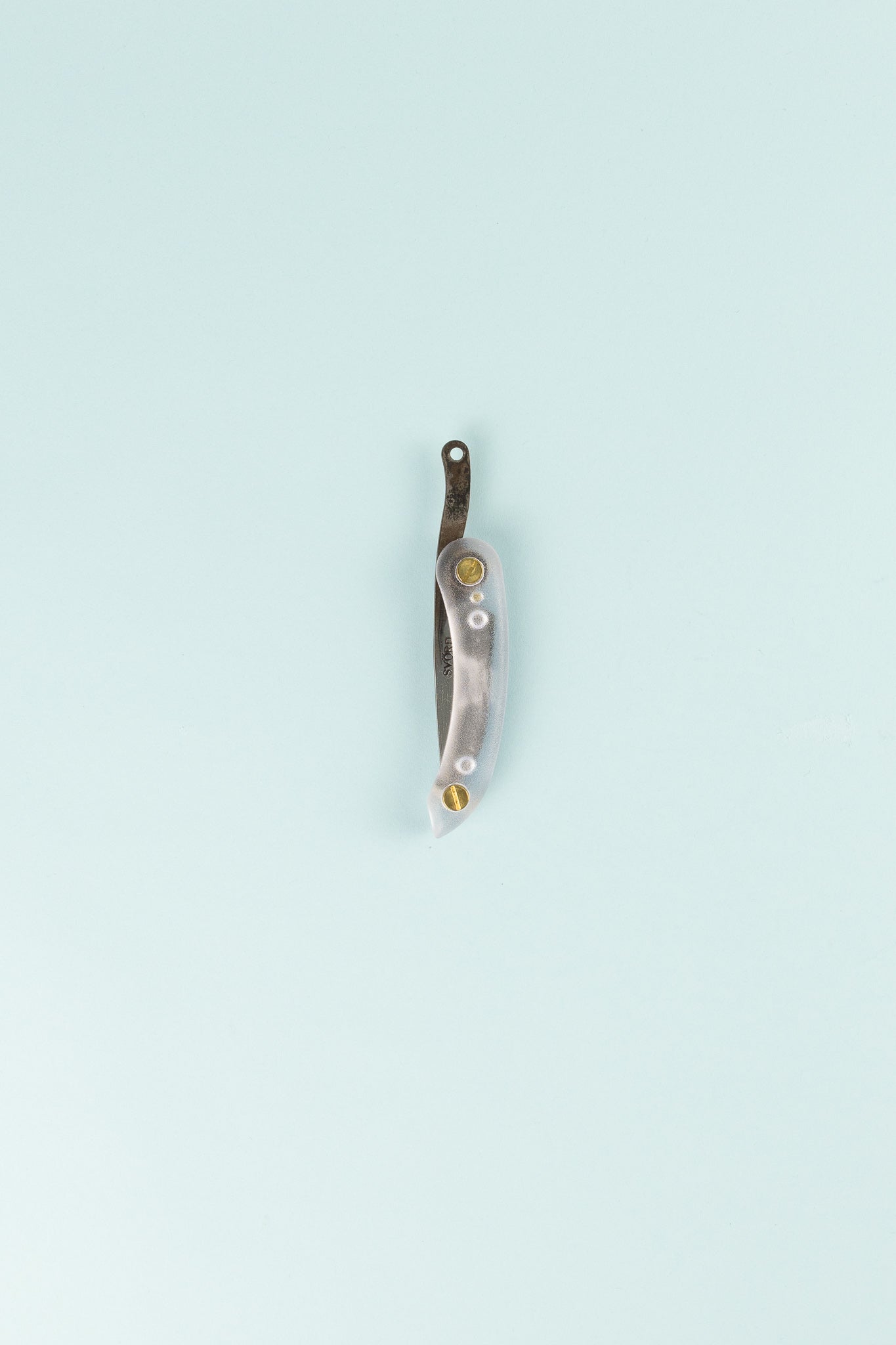 Peasant Knife Mini - Crystal on a light blue background, showcasing its sleek design and craftsmanship.