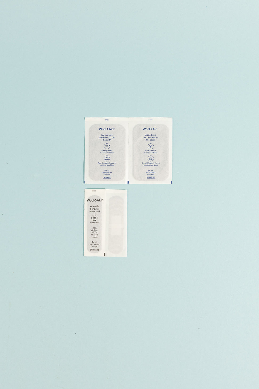 Merino Wool Adhesive Bandages emergency pack featuring individual bandages on a light blue background.